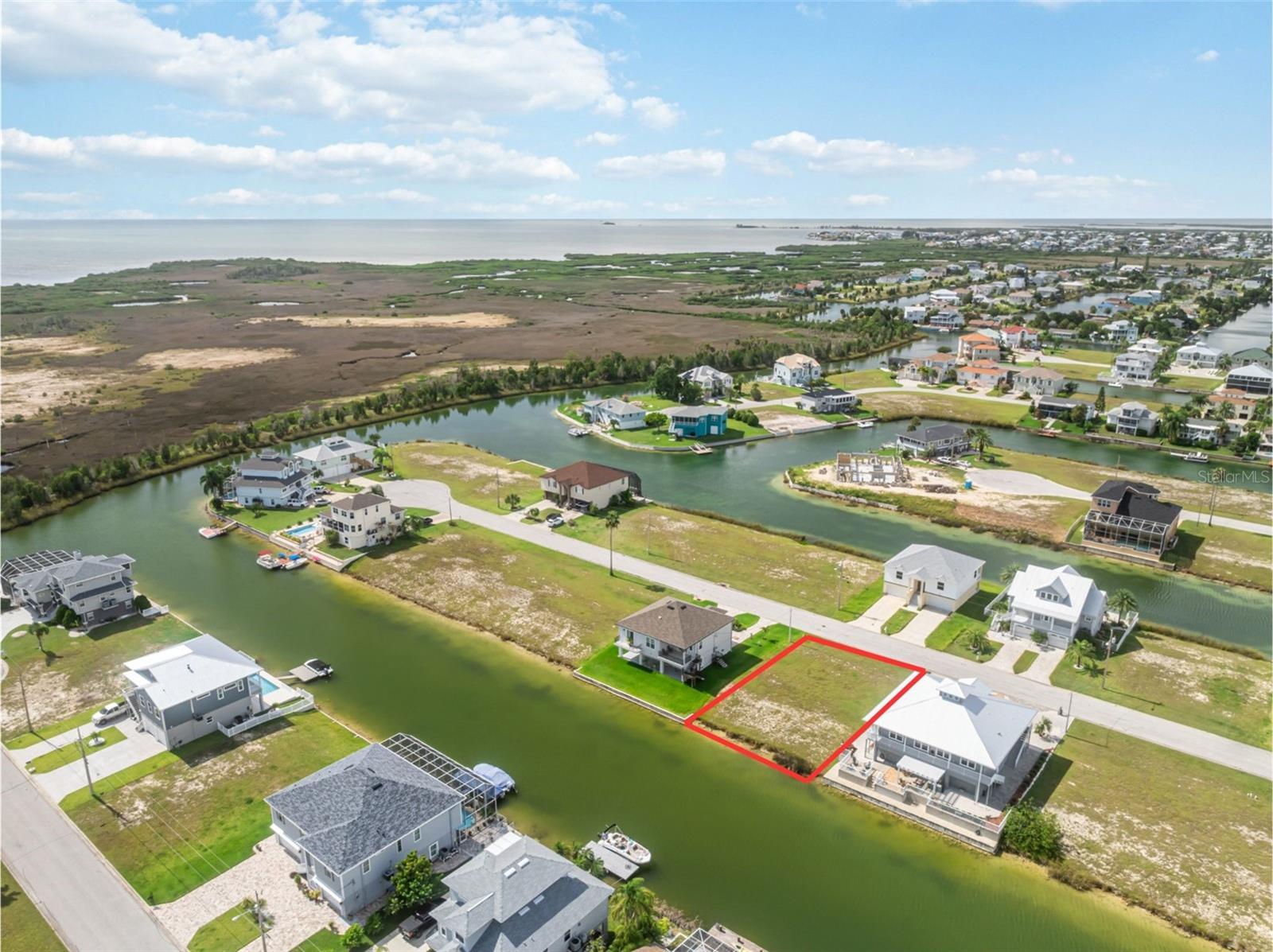 Discover the perfect canvas for your coastal dream home with this rare Hernando Beach building lot boasting serene water views and a true Gulf Coast vibe. With 75 feet of frontage on a sparkling spring-fed freshwater canal, this property offers an indirect route to the Gulf of Mexico — ideal for boating and fishing enthusiasts who love a bit of adventure. Your journey to open waters includes a boat lift to a saltwater canal and passage under a fixed bridge before reaching the Gulf.
Located in South Hernando Beach, this lot sits in an HOA community that maintains the neighborhood’s charm and provides access to a private community boat ramp. HOA guidelines keep the area peaceful by prohibiting short-term rentals, making this a haven for those seeking a true residential retreat.
Hernando Beach itself is a unique coastal gem — quiet, scenic, and celebrated for its boating and fishing culture. It’s bordered by the Gulf of Mexico on one side and the Weeki Wachee Nature Preserve on the other, connected by a coastal two-lane highway with only a few entry points, which adds to its tucked-away feel.
While there’s no traditional sandy beach, you’ll find plenty of coastal character here — think waterfront tiki bars, marinas, seafood markets, and local restaurants that make every day feel like vacation. And when you need convenience, you’re just 10 minutes from US-19, with Publix, shopping centers, Walmart, Sam’s Club, chain restaurants, and four major hospitals close by. Even better, you’re only about an hour from Tampa International Airport and roughly 90 minutes to Disney.
This lot is more than just land — it’s the start of your Gulf Coast story. Build your fishing getaway, your forever home, or your peaceful escape right here.