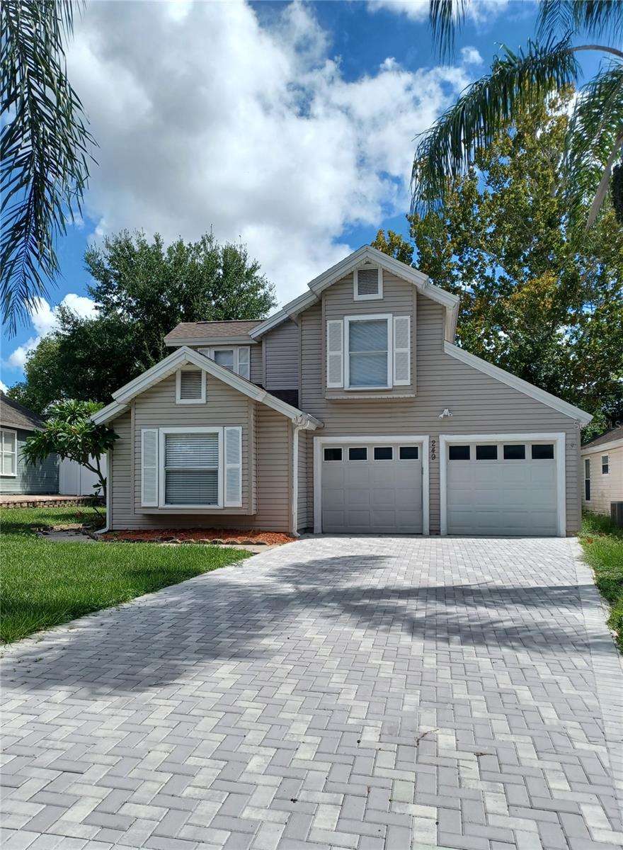 Epic location, just minutes from Universal and International Drive. This Frisco Bay home is ready now for you and your family to move in. New AC unit and carpet in July 2025, newer roof in 2022 and updated interior finishes. The recently updated kitchen is sure to impress. The white, Shaker style, wood cabinets have four corner cabinets that provide maximum storage. The new granite counters and open view to the living room further enhance this homes appeal. The light and bright planter bay window welcomes the sunrise each morning with views of the green space, open area to the east. The dining area has a sliding glass door to the rear yard patio. The kitchen and dining area are tiled. The living room feels open and airy with a vaulted ceiling and two large windows that have a beautiful view of the treed backyard and open space. The first floor, main bedroom has an en suite full bathroom, window seat and walk in closet that assure comfort and convenience. The main bedroom has laminate flooring. The staircase ascends to the second and third bedrooms and the hall bathroom. The second and third bedrooms all have new carpeting. The attached 2 car garage has washer and dryer hookups and plenty of space for 2 vehicles and storage. The driveway has recently been upgraded with brick pavers for a contemporary look. The large rear yard is perfect for pets and possibility of adding a screened porch or swimming pool in the future. Frisco Bay HOA amenities include a community swimming pool and cabana, large playground, tennis and Pickle ball court. The semi annual dues are reasonable. Furnished MLS photos have been virtually staged. The house is unfurnished.