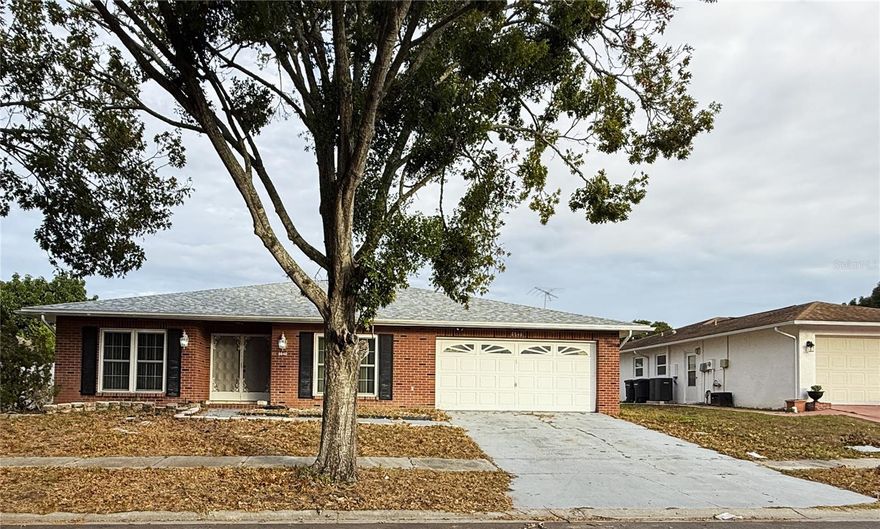 This spacious 3-bedroom, 2-bath home offers an open floor plan with a bright and airy atmosphere, highlighted by large windows, laminate/ceramic floors, and a wide foyer that welcomes you through elegant double-entry front doors. The two additional bedrooms are perfect for guests, or a home office. Both the family room and master bedroom open through French doors into a beautiful Florida Room with classic brick flooring, creating an ideal space for relaxing or entertaining. The home also features a convenient laundry room equipped with a tub, washer, and dryer, along with a master suite that includes a private bathroom and walk-in closet. Outside, the private backyard provides a charming patio area perfect for gardening, BBQs, or enjoying peaceful evenings outdoors. Close to Hwy 19 restaurants and all other service businesses.