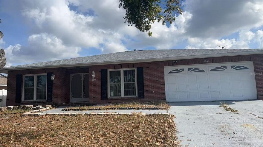 This spacious 3-bedroom, 2-bath home offers an open floor plan with a bright and airy atmosphere, highlighted by large windows, laminate/ceramic floors, and a wide foyer that welcomes you through elegant double-entry front doors. The two additional bedrooms are perfect for guests, or a home office. Both the family room and master bedroom open through French doors into a beautiful Florida Room with classic brick flooring, creating an ideal space for relaxing or entertaining. The home also features a convenient laundry room equipped with a tub, washer, and dryer, along with a master suite that includes a private bathroom and walk-in closet. Outside, the private backyard provides a charming patio area perfect for gardening, BBQs, or enjoying peaceful evenings outdoors. Close to Hwy 19 restaurants and all other service businesses.