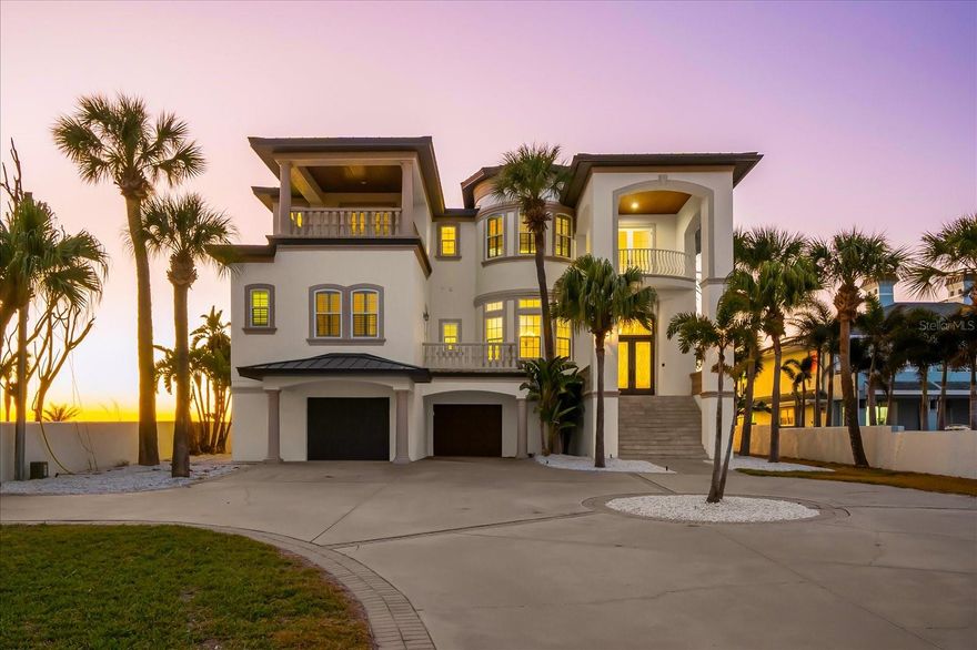Under contract-accepting backup offers. Perfectly positioned on 80 feet of direct Gulf frontage in the exclusive enclave of Belleair Beach, this extraordinary three-story coastal estate offers 7,528 square feet of refined beachfront living on an expansive 0.44-acre lot. Designed for both elevated entertaining and effortless everyday comfort, the residence showcases soaring ceilings, elegant crown molding, multiple gathering spaces with fireplaces, and seamless transitions to expansive Gulf-front balconies with sweeping panoramic water views. The chef’s kitchen is thoughtfully appointed with premium appliances—including a cooktop, range, refrigerator, freezer, and dual dishwashers—along with a high bar for casual dining and a fully equipped wet bar to enhance entertaining. The home features five spacious bedrooms, six full bathrooms, and two half baths, including a third-floor primary suite measuring approximately 21 by 18.5 feet, offering plush comfort and breathtaking Gulf vistas. Secondary bedrooms are generously sized with en-suite baths to ensure privacy for family and guests. A private elevator services all levels, while ceramic and quarry tile flooring in the main living areas is balanced by plush carpeting in the bedrooms. Additional highlights include a two-car attached garage, concrete seawall with uninterrupted water access, an aluminum standing seam roof (2025), impact windows and doors (2025), replaced A/C units (2025). With sugar-white sands just beyond your door and unobstructed Gulf views from nearly every vantage point, this estate presents a rare opportunity to own a legacy waterfront property where privacy, elegance, and coastal sophistication converge.