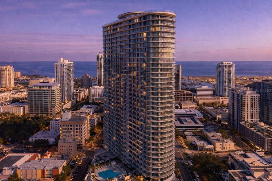 Live above the energy of downtown at The Residences at 400 Central, a striking 46-story condominium tower shaping the St. Petersburg skyline. This 14th-floor residence offers elevated city living with sweeping views and a refined, modern design. Featuring an open-concept layout with floor-to-ceiling glass and an expansive private terrace, the home captures wide-ranging vistas that stretch from Tampa Bay toward the Gulf of Mexico. Natural light fills the interiors, creating a seamless connection between indoor comfort and the surrounding skyline. This specific residence includes all available builder upgrades, showcasing enhanced finishes, upgraded fixtures, and thoughtfully selected design elements that elevate both style and functionality. Residents enjoy access to an extensive collection of amenities, including a 46th-floor Sky Lounge Observatory, resort-style pool deck, fitness and wellness center, theater lounge, private dining spaces, co-working areas, concierge services, and valet parking. Located in the heart of Central Avenue, 400 Central places dining, arts, entertainment, and the waterfront within convenient reach—offering a lifestyle that blends elevated living with the vibrancy of downtown St. Petersburg.