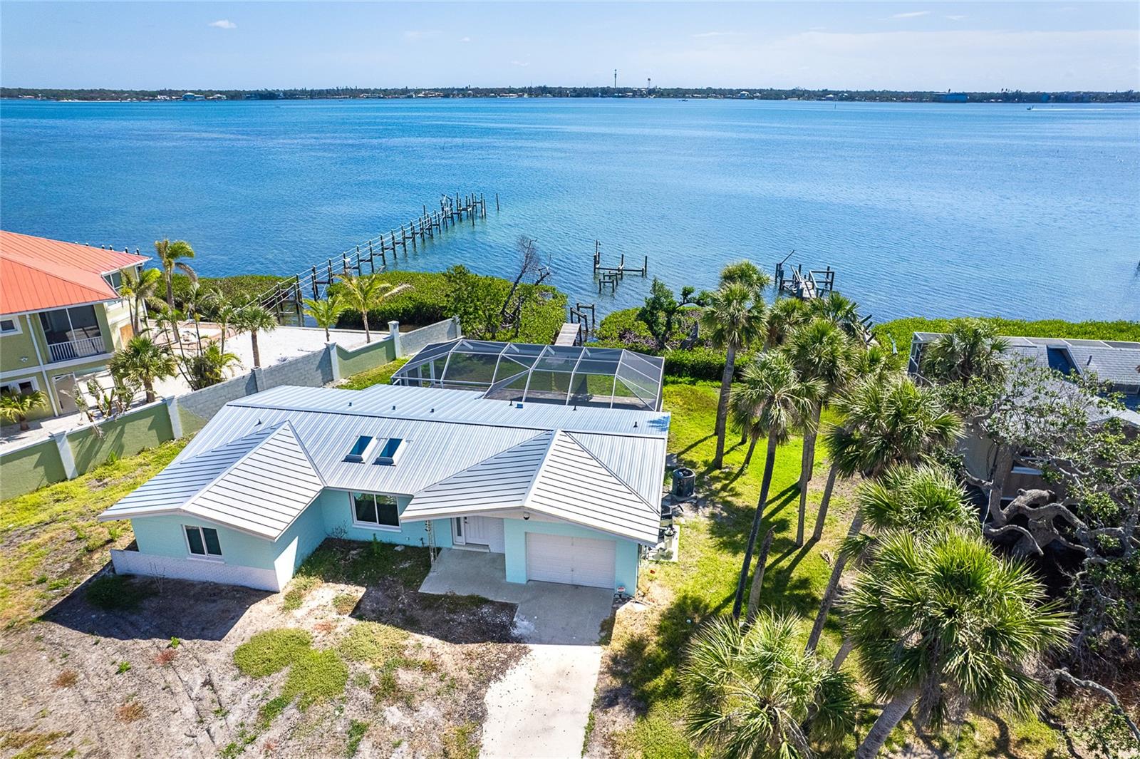 MANASOTA KEY – BAYFRONT HOME WITH DOCK & DEEDED BEACH ACCESS
This home sustained storm surge damage and is being sold as is. It is a fantastic opportunity to restore and personalize a rare waterfront property on Manasota Key. Welcome to Pelican Shores, where this charming 2-bedroom, 2-bath pool home with a 1.5-car garage sits on an impressive nearly one-third-acre lot and 71’ foot of water frontage—offering direct access to the Intracoastal Waterway, a private deeded dock, and community deeded beach access just steps across the street. Whether you're envisioning morning beach walks, launching a kayak, or boating directly from your backyard, this home delivers the ultimate Florida lifestyle. The spacious lanai and caged pool, added in 2020 with stylish brick pavers, is the perfect place to relax and entertain while taking in stunning sunrises over the Bay. In the evenings, cross the street and head for the beach for breathtaking Gulf sunsets. Although the home was affected by the recent storm, many key features remain intact—all windows are Hurricane Impact-rated and undamaged. The sliding glass doors in both the kitchen and living room are currently being replaced with new Hurricane Impact, already ordered for installation. The interior showcases cathedral ceilings, polished Terrazzo floors, and a spacious kitchen that flows into a large utility room for your washer and dryer, and a convenient full guest bath located off the laundry area and garage—designed for practical, everyday living. The formal living and dining rooms offer direct access to the lanai through the soon-to-be-installed sliding glass doors, and both bedrooms are generously sized, providing plenty of comfort and space. This is a rare chance to own on the Intracoastal Waterway in a location just moments from local restaurants, entertainment, and all that Manasota Key has to offer. Don’t miss this opportunity, call today to schedule your private showing.