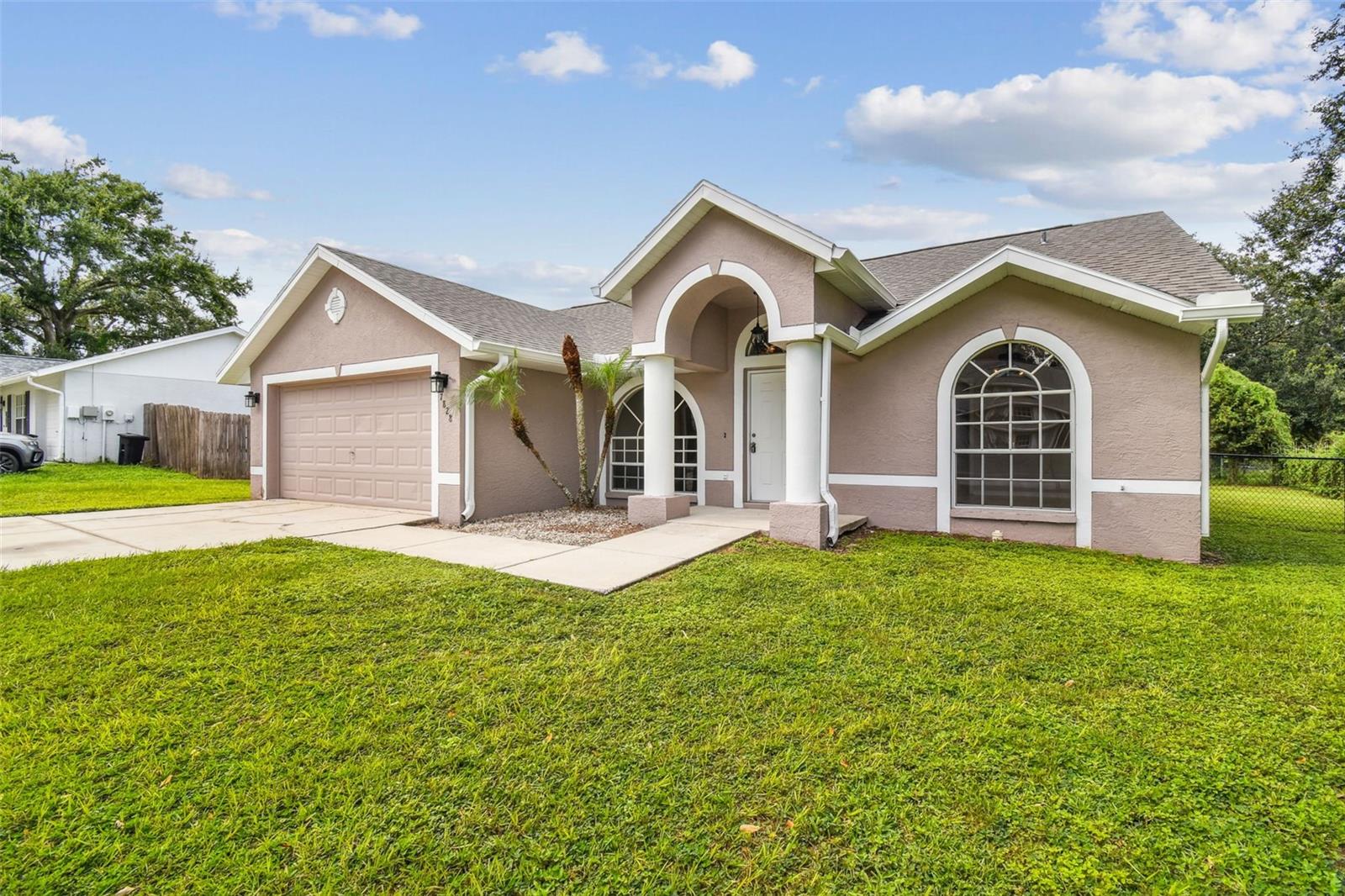 Clean 3 bedroom 2 full bath block home in Lakeview Knoll located in Zephyrhills. .29 Acre corner lot with a big, fenced back yard with a patio, Split bedroom layout, great room, breakfast bar, good size kitchen, 2-car garage. New roof in January of 2024. There are NO CDD fees and No Homeowners Association. Major big block stores, grocery stores and restaurants are two miles away.