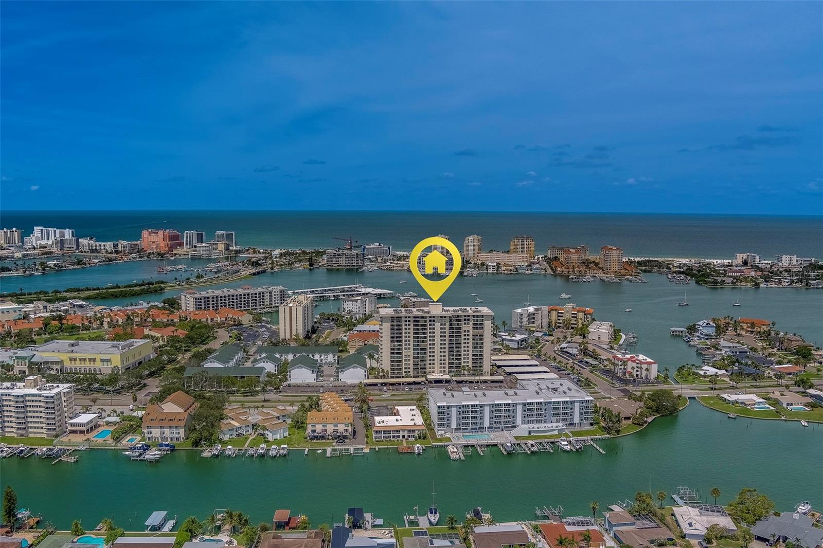 Welcome to a beautifully maintained 2-bedroom, 2-bathroom condo offering breathtaking Intracoastal views and the ultimate in low-maintenance living. Enjoy a bright and airy interior with brand new windows, sliding glass doors, and stylish plantation shutters that enhance the abundance of natural light. Step onto your private balcony to soak in the serene water views and refreshing coastal breeze. Inside, you'll find a BRAND NEW AC, 2022 water heater, and the convenience of an in-unit washer and dryer. The community offers resort-style amenities including a heated pool and spa surrounded by tropical landscaping, cabanas, and lounge chairs, as well as a fitness center, community room with kitchen, bike storage, and personal storage locker (#63). The HOA covers everything except electricity, making for truly hassle-free living. This all-ages community allows rentals immediately with a 3-month minimum, making it ideal for full-time residents or seasonal use. Live the island lifestyle just moments from world-famous Clearwater Beach, and close to shopping, dining, bars, and the Clearwater Marine Aquarium. Don’t miss your chance to own a slice of paradise!
