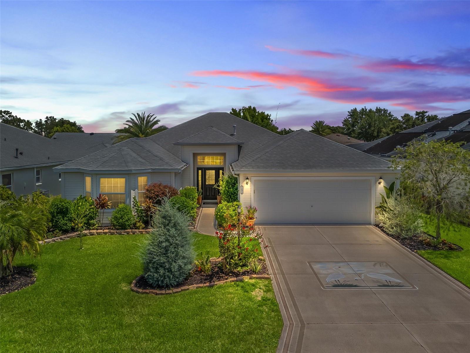 Spacious 3/2 Juniper in Sunset Pointe with Enclosed Lanai & Expanded Garage! This well-maintained home features a NEWER ROOF (2020), flowing luxury plank vinyl flooring throughout, newer HVAC (2015), NEW HOT WATER TANK (2025), and enhanced landscaping creating privacy behind. The open floor plan offers high ceilings, a large living/dining area, and a bright eat-in kitchen with upgraded stainless steel appliances, a gas stove, and a French door refrigerator. The primary suite includes a vaulted ceiling, walk-in closet, and en suite with double vanities and tiled walk-in shower. Guest bedrooms have flexible use, including one with a bay window. The guest bath also features a tiled walk-in shower. Enjoy privacy in the enclosed lanai and relax on the elevated rear patio. The 27’ x 24’ EXPANDED GARAGE provides ample room for two cars, a golf cart, and storage. GAS utilities. Centrally located near Lake Sumter Landing, Cane Garden Country Club, numerous executive golf courses, pools, and recreation. The remaining bond balance is $5927. Make your appointment today and let’s get you living the dream in The Villages!