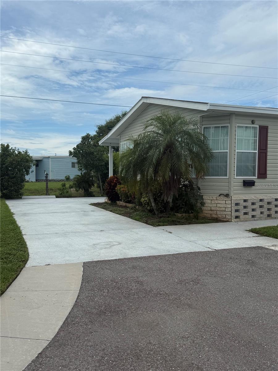Spacious 2 bedroom, 2 bathroom manufactured home with office (easily converted back into a 3rd bedroom) tucked away in the back of the desirable Sunset Palms community. This home offers over 1,600 sq ft of living space, vaulted ceilings, and includes a $55,000 land share.
Features include a fully furnished interior, bicycles, golf cart, and a workshop equipped with tools, and a tucked away safe. The upgraded panels in the enclosed Florida Room provide year-round enjoyment. Surrounded by mature landscaping, residents can enjoy natural views and local wildlife from their own backyard. Sunset Palms is an active, 55+, resident-owned community conveniently located 15 miles from Tampa International Airport, 7 miles from St. Pete–Clearwater International Airport, and approximately 20 minutes from Indian Rocks Beach. Community amenities and nearby attractions provide endless opportunities for recreation and entertainment.