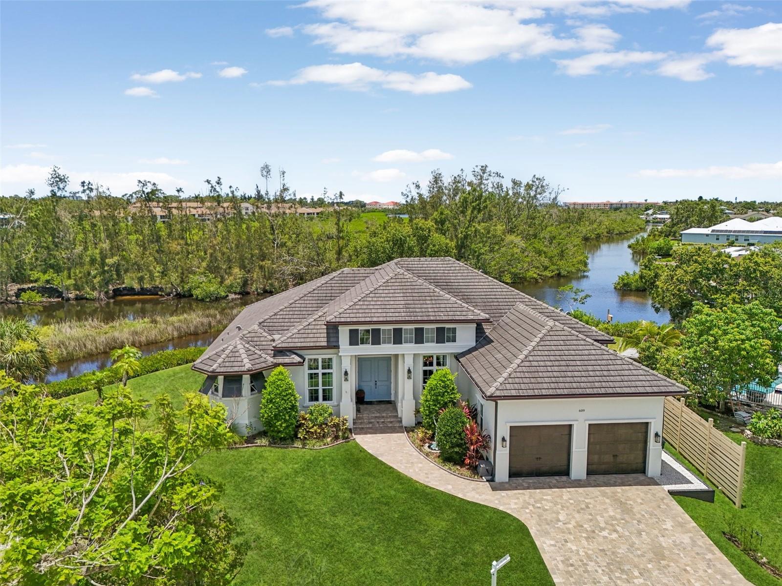 Waterfront Paradise on Curry Creek!! Discover your own slice of paradise in this breathtaking waterfront sanctuary, where every detail invites you to embrace the tranquility of nature. Situated at the end of the cul-de-sac on over 1/3 acre of lush serene surroundings, this home is a haven for wildlife enthusiasts, kayakers, boaters, and anglers. Enjoy direct access to Roberts Bay and the Gulf of Mexico just minutes from your private dock. The outdoor living space is nothing short of spectacular, offering 270-degree views of a pristine preserve. Whether you’re basking in the sun by the heated pool and spa, dining alfresco, or relaxing by the cozy fire pit set up for outdoor movie nights, this oasis is designed for unforgettable moments. Marvel at the vibrant wildlife and stunning sunsets, all from the privacy of your own backyard. Walk through your front door and leave the world behind!
Inside, the home boasts 13-foot ceilings and an open, thoughtfully designed floor plan. The gourmet kitchen is a chef’s dream, featuring a spacious island with wine storage, custom wood cabinetry, natural stone countertops, and tray ceilings. Top-of-the-line appliances include a gas cooktop, dual built-in ovens (one microwave convection), a French door refrigerator, and a dishwasher, with a walk-in pantry offering ample storage. The master suite is a serene retreat with picturesque water views, coffered ceilings, and custom built-ins. Step out onto the lanai for your morning coffee or unwind in the spa-like master bath, complete with dual vanities, a freestanding soaking tub, and a double rain shower. The master suite provides plenty of storage space for each occupant that includes a generous walk-in closet with custom shelving and a separate custom built-in system with drawers and hanging storage. On the opposite side of the home are the two guest suites, each with a private en-suite bath (one with pool access) and walk-in closet for ultimate comfort and privacy. Completing this fabulous layout is a den/office with double French doors for privacy.
Important architectural features of this home include hurricane standard solid block construction with impact windows and doors throughout, a finished floor elevation of 12.1’, hardwood floors throughout (no carpet!), 8 feet of stackable disappearing sliders, custom ceiling treatments, top-of-the-line insulation, solid 8-foot interior doors, central vacuum system, integrated structured wiring, 250 gal propane gas tank, a rain gutter system that distributes rain water throughout the property and the ultimate man cave - an oversized, insulated, finished garage (easy to climatize) with hurricane reinforced garage doors, 14-foot ceilings, and ladder access to attic storage.
Ideally located, this home offers easy access to the Legacy Trail and popular local spots like Pops, Nokomo's, Chaz, Star Thai, Prime, La Botte, and Café Evergreen. With US-41 and I-75 nearby, downtown Venice is just 5 minutes away, and Sarasota is only a 20-minute drive. Nokomis Beach is just a 5-minute trip, and top-rated schools like Pine View are within 10 minutes. Just 3 minutes away is Sarasota Memorial Hospital’s new state-of-the-art campus fueling the area’s expanding growth in medical facilities, retail, office, and residential communities. Nokomis is fast becoming a vibrant and sought-after hamlet! Offered turnkey furnished, schedule your private showing today and experience this extraordinary home firsthand!