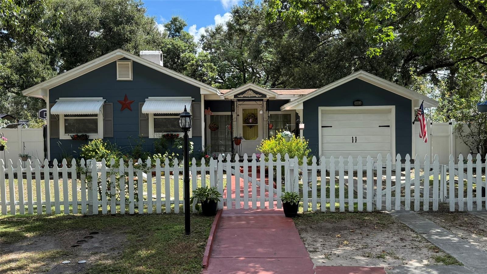The cutest house in Zephyrhills! Don't miss your opportunity to make this beautiful five bedroom, two bathroom, cozy but spacious craftsman style house with a full finished basement and massive yard, your forever home.
Located on 10th street, in the quiet downtown historic district of Zephyrhills, near restaurants, stores, and schools, as you approach this charming home you are greeted by the incredible curb-appeal, beautifully landscaped, with decorative lighting and a classic white picket fence. This home, on it's oversized lot is all about privacy. With it's stunning frontage, the backyard is completely private, hidden away behind 6' tall vinyl privacy fencing.
Entering the home you are greeted by a warm, cozy sitting room that leads into the beautifully updated farmhouse style kitchen with all modern appliances and counters and tile-work.
With the four ample sized main level bedrooms and nicely updated, yet classic bathroom, you will always feel completely comfortable in your new home.
One of the most unique things about this home is it's fully finished basement, set up as a completely separate suite with it's own entrance. Finding a home in Florida with a basement is extremely rare so don't miss your chance to own a one-of-a-kind property.
With multiple areas, from the large living room, to the outside deck, huge covered patio area with an incredible brick oven, and oversized private back yard, this home is perfect for relaxing and hosting friends and family.
This home has been loved, and meticulously maintained and has recently installed central air conditioners on the main floor, and a mini-split unit in the basement.