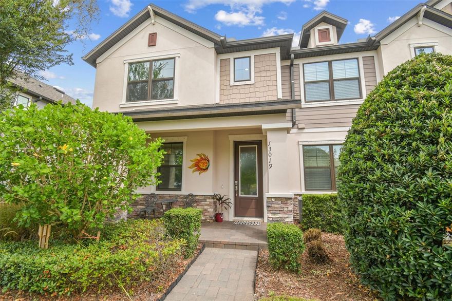 EXTERIOR MAINTENANCE FREE and move-in ready south facing townhome in highly sought-after Starkey Ranch in Odessa, FL, is now available. This STUNNING 2017 craftsman style townhome offers 3 bedrooms, plus flex/office space/ 2.5 bathrooms, a 2 car garage and is an END UNIT offering a water view, beautiful native landscaping and a spacious paver front porch. Once inside, take note of the show stopping 2-story entrance with BALCONY and gorgeous engineered espresso hard-wood staircase. There is UVA security film on upstairs windows and front door to protect them should they be hit and also helps in maintaining a cooler temperature. Modern wood-like tile flooring throughout the main level. Upgraded 5 1/4 inch baseboards. Newer interior paint. Continuing through to your left you have the flex space with french doors perfect for an office, craft room, play room, or a 4th bedroom (no closet). Designer lighting lights up the foyer that leads you to the heart of the home. Laundry room is on main floor providing additional storage area. Washer and dryer included. 1/2 bath for convenience. The living room is light and bright and connects to the kitchen for easy entertaining/conversation. Unique SHIPLAPPED electric fireplace with mantle makes for a cozy and inclusive space. Shiplapped granite island for additional seating, ample counter space with custom backsplash and under cabinet lighting. 42 inch espresso cabinets with thicker trim molding adds elegance. Spacious pantry. Upstairs enjoy NO CARPET and the newer luxury vinyl flooring detailed with quarter round. On one side you have a large bedroom that is very quiet and private. Full bathroom is shared with this room and the 2nd spacious room and has a tiled shower with listello details, a built-in wall niche, and granite sink. On the other end is the primary retreat with beautiful window views and privacy. Ensuite bathroom provides walk-in shower with tile and listello details and built-in wall niche. Both bathrooms have custom mirrors. From the kitchen, open the side door to you outdoor oasis that is screened in. This is certainly an additional space to relax and unwind in and you can utilize it all year! Off of the porch/lanai is the 2 car garage with epoxy flooring. This home is situated perfectly within the community nearing both entrances. The Starkey K8 school is close as well as grocery, restaurants, medical, and entertainment. You have access to the 3 community pools, green space, parks, and trails. Parking spaces along the front of the townhomes are there for convenience. BRAND NEW exterior paint 9/2025.