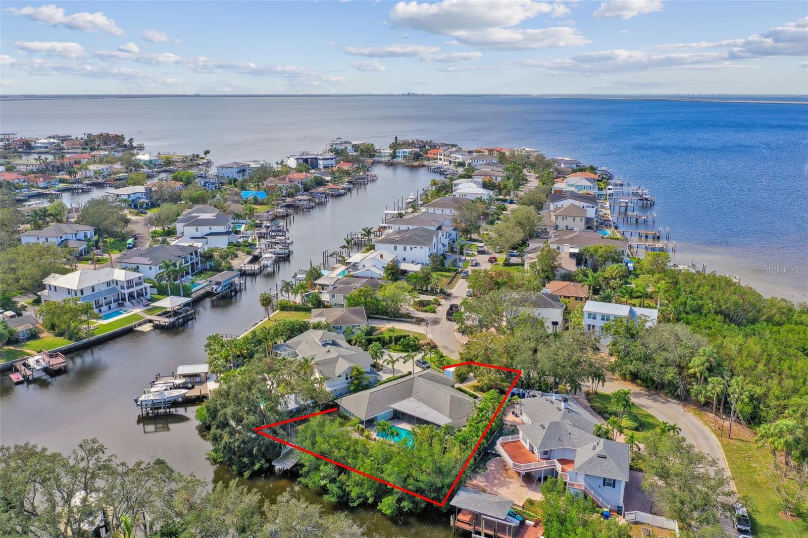 Discover this rare oversized .32-acre waterfront property located on a dead-end street in the heart of Sunset Park. This property offers an impressive 127 feet of water frontage on a deep-water canal that provides direct access to Tampa Bay. Embrace the best of both privacy and panoramic water views from this unique 14,000sq.ft. pie-shaped lot, where the expansive backyard and pool create an ideal outdoor retreat. The current home features four bedrooms, three bathrooms, a two-car garage, and two separate master bedrooms with en-suite baths. While the home experienced approximately 12 inches of water from Helene, it’s ready to be restored to its original charm. Alternatively, it’s the perfect canvas for building your new dream home in this sought-after neighborhood, known for its A-rated schools (Mabry, Coleman, and Plant) and unmatched convenience to everything Tampa Bay has to offer.