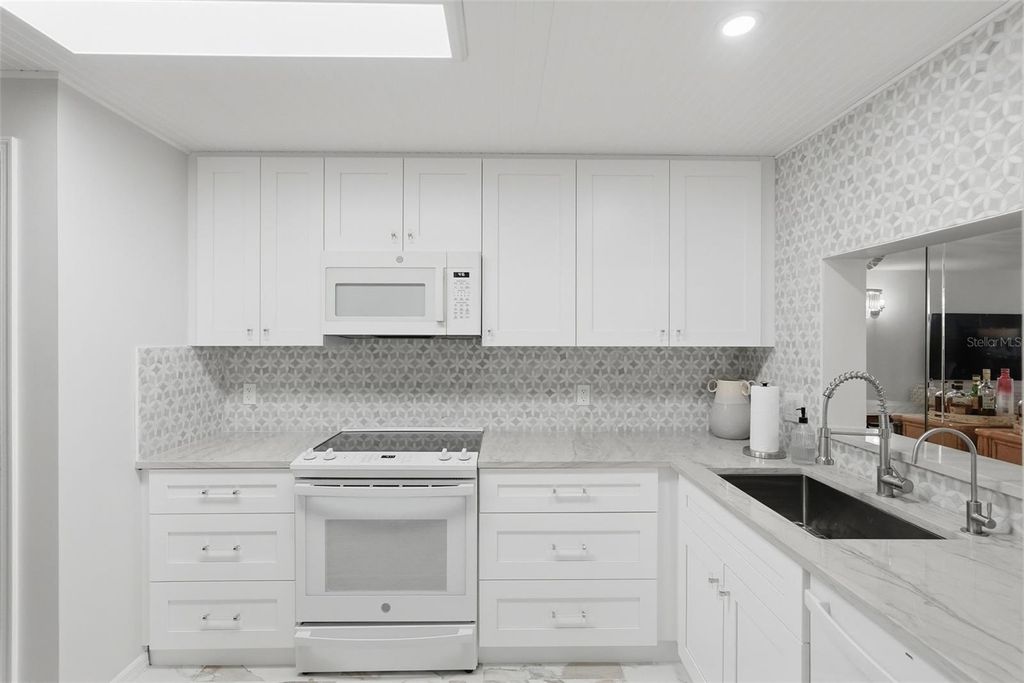 Photo of 6600 Sunset Way #410, St Pete Beach, FL 33706 (MLS # TB8473866)