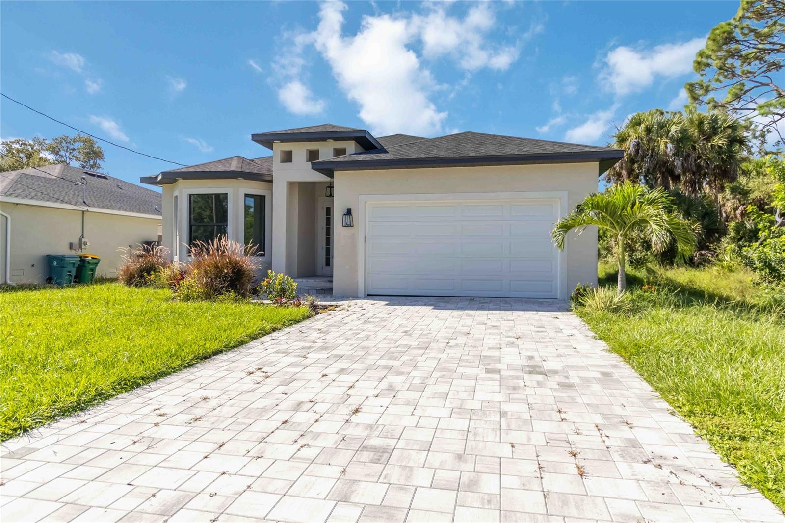 This brand-new, custom-built residence is nestled in the serene deed-restricted community of Rotonda Heights in Rotonda West. Designed for comfort, efficiency, and style, this home offers a peaceful retreat with every modern convenience.
Step inside to an open and bright floor plan featuring tray ceilings and ceiling fans in the living room and all bedrooms. The kitchen showcases sleek quartz countertops, stainless steel appliances, ample cabinetry, and a stylish ceramic tile backsplash. Upgraded fixtures throughout the home add a touch of sophistication.
The primary suite features a tray ceiling, a spacious walk-in closet, and an ensuite bathroom with dual vanities and a walk-in shower. Additional bedrooms provide comfort for family or guests.
Enjoy year-round Florida living on the fully tiled lanai with ceiling fans, perfect for entertaining or relaxing. The paver driveway and curb appeal set the tone for the quality inside, while CITY WATER and SEWER provide convenience.
Built with energy efficiency and safety in mind, the home includes spray foam insulation and hurricane-impact windows.
Close to schools, shopping, dining, golf courses, and world-famous beaches and barrier islands such as Manasota Key and Boca Grande, this property offers the best of Southwest Florida living.
Do not miss the chance to call this modern masterpiece your new home.