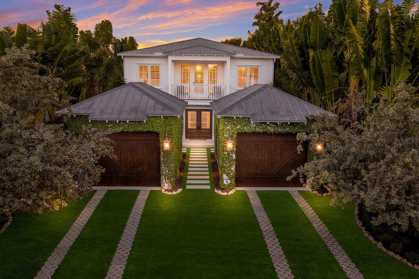 Indulge in the pinnacle of coastal luxury at this extraordinary 3-bedroom, 2.5-bathroom custom residence, where opulent high-end finishes and fabulous pecky cypress floors grace every corner. Revel in the impeccable features, including Sub -Zero and Wolf appliances, marble counter tops, Shaw’s sinks, custom woodworking and an abundance of natural light throughout. Chefs kitchen with butcher block island, 6 burner gas stove with pot filler and custom cabinetry. The dining area seamlessly opens to the expansive upstairs covered deck, providing an exquisite backdrop for outdoor dining. The master suite features a coffee bar with sink and fridge, ensuite bath with dual vanities, walk in shower and custom closets. The laundry room offers wonderful built-ins for extra storage and a lovely Shaw’s utility sink. There is also a bonus room with custom wood ceilings plus an office that would work well as a wellness studio or workout/yoga space. Step onto the screened lanai and bask in the lavish heated pool and spa, all surrounded by low-maintenance artificial turf and landscape lighting that creates the perfect oasis within the lush, tropical landscape allowing for total privacy. Two detached single-car garages offer ample storage for all your toys. While this exquisite residence has never been used as a rental, the opportunity for short-term rentals exists, making it an alluring investment. Embrace the unparalleled convenience of walking to the beach and Pine Ave where dining and shopping is a breeze.