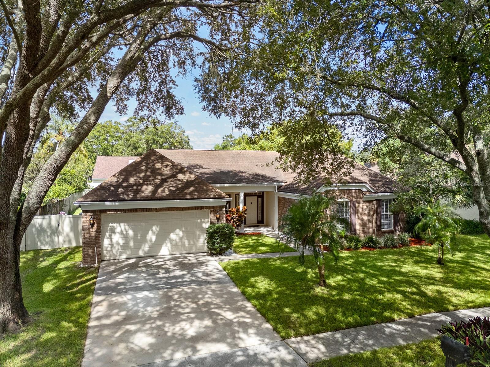 Welcome to this exceptional 4-bedroom, 3-bath, 2,604 sq. ft. pool home in the highly sought-after community of Farmington Village located in Odessa. Completely renovated in 2021, this residence blends modern style with functional design, offering move-in-ready perfection. Step into the gourmet kitchen, featuring granite countertops, soft-close cabinetry, stainless steel appliances and contemporary lighting. The open layout flows seamlessly into the spacious family room, highlighted by a cozy fireplace and direct access to the pool area. Formal living and dining rooms offer elegant spaces for gatherings, both with views of the screened lanai and sparkling pool. All bathrooms have been beautifully updated with new flooring, upgraded cabinetry and stylish lighting. The pool bath—just off the kitchen—features non-slip tile for safety and style. Throughout the home, luxury vinyl plank flooring adds warmth and durability. Additional highlights include an oversized two-car garage, a large walk-in pantry adjacent to a dedicated office nook, and a spacious laundry room with deep sink and built-in ironing board. The fourth bedroom features custom shelving, making it ideal for a home office, craft space, or guest suite. Perfect for entertaining, the expansive screened lanai offers paver flooring, plumbing and electric for a future outdoor kitchen, and plenty of space to relax by the pool. The fully fenced backyard adds privacy and room to play. All this in a prime location—just minutes to shopping, dining, top-rated schools, major highways, Tampa International Airport (20 minutes), and the Gulf beaches (30 minutes). This absolutely stunning home is a must see!!!