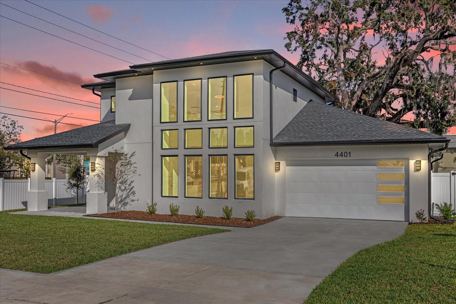 One or more photo(s) has been virtually staged. **NEW CONSTRUCTION** CUSTOM BUILT HOME with DETACHED INCOME PRODUCING ADU** Welcome to this beautifully crafted new construction home in the highly desirable Dover Shores neighborhood. This thoughtfully designed home offers 3,117 square feet of elegant living space with 4 bedrooms, 3.5 bathrooms, and a 2-car garage, complemented by a separate 503-square-foot, 1-bedroom, 1-bathroom guest house above an additional 1-car garage. As you approach, a grand entrance with a wall of windows greets you, flooding the space with natural light. Inside, you’ll find engineered hardwood floors throughout, complemented by pristine porcelain tile in each bathroom. The spacious living room features a stunning electric fireplace framed by floor-to-ceiling travertine, creating a warm yet sophisticated atmosphere, with 10-foot ceilings enhancing the airy, open layout. The chef’s kitchen is a culinary dream, featuring a large island with seating, stainless steel GE appliances, and a walk-in pantry for all your storage needs. The open-concept dining and living area provides ample seating options, and the multi-panel sliding glass door leads out to the rear lanai, seamlessly blending indoor and outdoor living. The downstairs primary suite is a tranquil retreat, featuring a tray ceiling, expansive walk-in closet, and a luxurious bathroom with dual sinks, a large soaking tub, a separate shower, and a private commode. An additional guest bedroom with an en-suite bathroom on the main level offers flexibility, perfect for guests or a home office. For added convenience, this home offers laundry hookups both downstairs and in the spacious upstairs laundry room. Upstairs, two more bedrooms, a full bathroom, and a loft area provide additional living space, with plenty of storage throughout. The guest house is a gem, complete with a private entrance, laundry hookups, additional storage, and separate water and electric meters, making it ideal for rental income, whether as a short-term or long-term rental. Set on a spacious corner lot with a mature oak tree providing shade, the home includes a vinyl fence and an irrigation system for easy maintenance. Conveniently located near Lake Underhill and its public boat ramp, this property also offers quick access to the Hourglass District’s popular dining scene, as well as the 408, placing you within 10 minutes of downtown Orlando and less than 20 minutes to UCF, the Orlando International Airport, and the Mall at Millenia. Experience the perfect balance of luxury, location, and flexibility in this exceptional Dover Shores property—ideal for those seeking refined living with additional income potential. Don’t miss your chance to make this beautiful residence your own!
