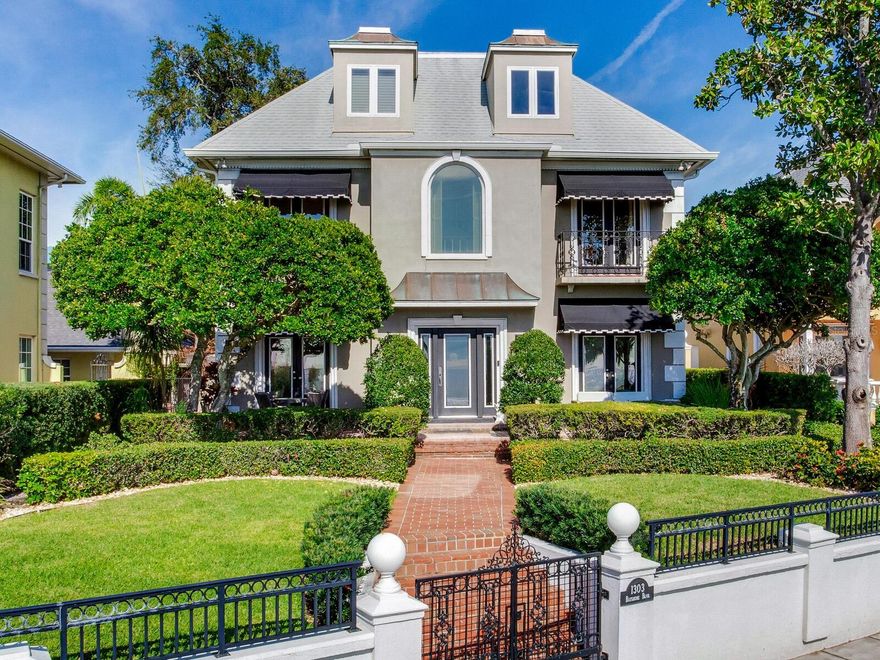 Don’t miss this rare opportunity to own this breathtaking 4-bedroom 3.5 bath timeless Bayshore Boulevard home in the most coveted neighborhood of Hyde Park Historic District. With awe-inspiring unobstructed water views on Tampa’s most prestigious walkway, this property is a must-see. The home has been thoughtfully designed and updated to ensure both traditional comfort and classic elegance.
The minute you enter the grand foyer entry, complete with a 3-story ceiling, wooden spiral staircase, arched doorways and plenty of natural light, you’ll feel right at home. The living room comes complete with wood-paneled moldings, an exquisite seating area with built-in book
cases, a wood-burning fireplace and hard-wood floors. There is also a formal dining room. The beautifully updated all-white gourmet “chef’s kitchen” features Carrara marble countertops and backsplash, a custom refrigerator and Thermador stove as well as a built-in microwave. The gorgeous center island is large enough to entertain a bevy of guests. There are 3 full large-sized bedrooms and 2 baths on the second floor. The private master suite on the third floor is complete with a luxury bath and spacious walk-in closet. Outside, entertain right in your private gated red-brick courtyard–perfect for year-round outdoor parties. Dine al fresco before walking out to watch the unmatched Bayshore sunsets right from your front yard. Additional features of the home include: a 2-car garage, 3 AC units, a built-in generator for the entire residence, as well as an alarm and irrigation system. This property is close to America’s best beaches, Tampa International Airport and walking distance to some of South Tampa’s best high-end shopping and restaurants. Named as the No. 1 best place to live in the Sunshine State by Forbes, Tampa’s prime location blends sophisticated architecture with breathtaking vistas. Don't pass up the opportunity to own this home that perfectly embodies the essence of luxury living in Florida.
