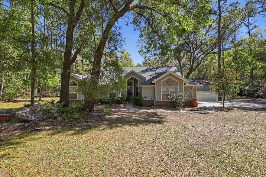 Tucked away on 2.54 private acres in a highly sought-after area of Alachua, this beautifully maintained 4-bedroom, 2.5-bath home offers the perfect blend of peaceful country living and everyday convenience—with NO HOA.
Step inside to discover a thoughtfully designed layout featuring vaulted ceilings, a spacious open-concept kitchen, and both a separate living and family room, ideal for entertaining or relaxing. The home is upgraded with new waterproof lifetime flooring, insulated windows, and stainless steel appliances, creating a modern and comfortable living space. A new Maytag front-load washer and inside laundry room with sink add even more convenience.
The split floor plan provides privacy, with a generous primary suite on its own side of the home, complete with a luxurious en-suite bath featuring a garden tub and separate shower.
Outside, you’ll fall in love with the fully fenced, park-like backyard shaded by gorgeous live oaks and dotted with your own producing ruby red grapefruit, orange, and lemon trees. Enjoy peaceful evenings on the porch swing, watching lightning bugs and local wildlife.
This property is packed with practical upgrades, including a whole-house generator, water filtration and purification systems, gutter guards, and a roof less than 10 years old. For hobbyists or extra storage, there’s both a 2-car attached garage and an impressive 3-bay detached garage.
Located outside city limits yet just minutes from everything, you’re only: 10 minutes to Jonesville, Newberry, and Alachua.  15 minutes to Gainesville.  Within 10 minutes of four Publix shopping centers
Additional features include Clay Electric utilities, Thursday garbage and recycling pickup, fiber optics, and Cox digital cable/internet availability.
If you’ve been searching for space, privacy, and convenience all in one—this exceptional property delivers it all. Schedule your private showing today and experience the charm for yourself!
*Some pictures have been virtually staged.