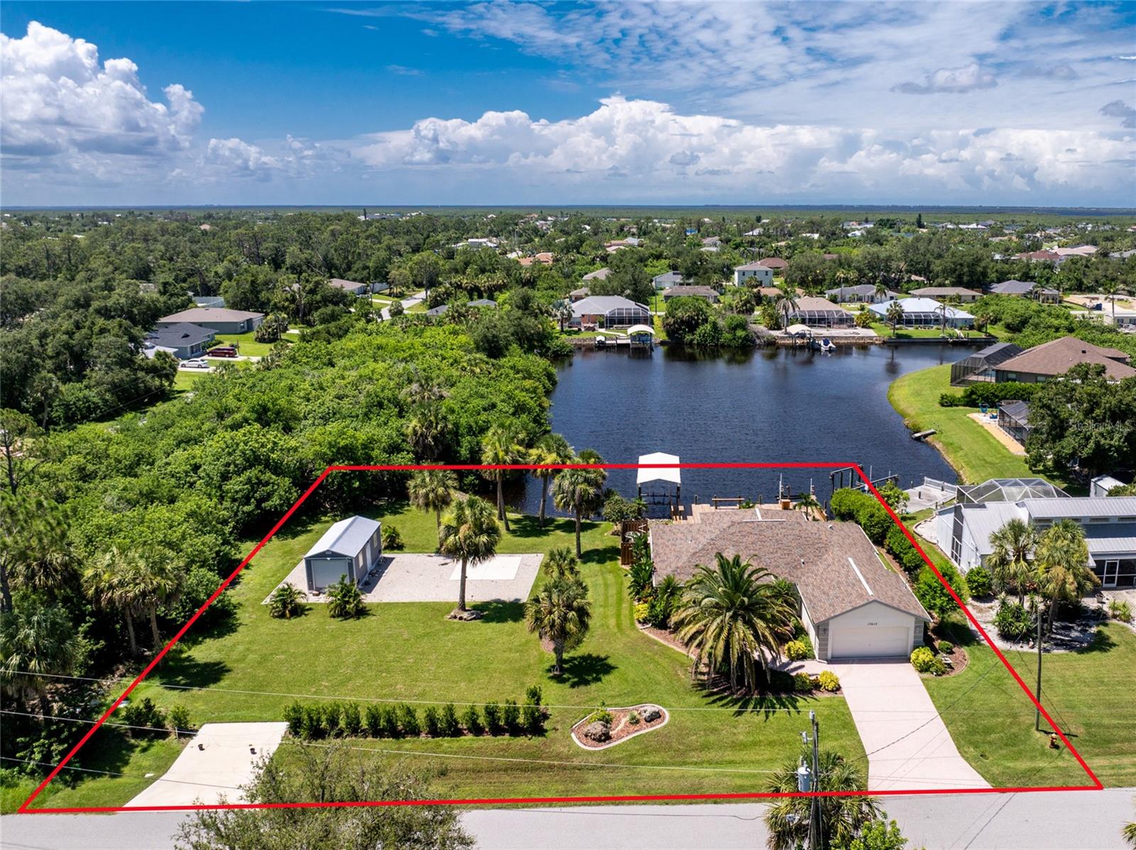 This is living on the water in SW Florida! Gorgeous brand new dock, 12,000# lift with cover and 125' of waterfront. This lovely 3/2 home is situated on a double lot, and you'll notice that expansive view from the minute you walk through the front door! The beautiful Kitchen boasts travertine backsplash, dark stainless appliances, and granite countertops. The Living Room provides access to the tiled Lanai and the outdoors. Split Floor plan allows for privacy for your guests. Laundry Room conviently located to Primary Bedroom, and leads out to the 2 Car Garage. The additional parcel hosts a 264 SF Work Shop with power, and an RV Pad, and offers extra space for that private feel. The Roof was replaced in 2019, A/C unit and Hot Water Heater in 2024, plus the Home features Hurricane protection. This all adds to peace of mind.
Just imagine the fishing, the boating, the parties, the morning coffee or evening cocktails you'll enjoy. These memories await!