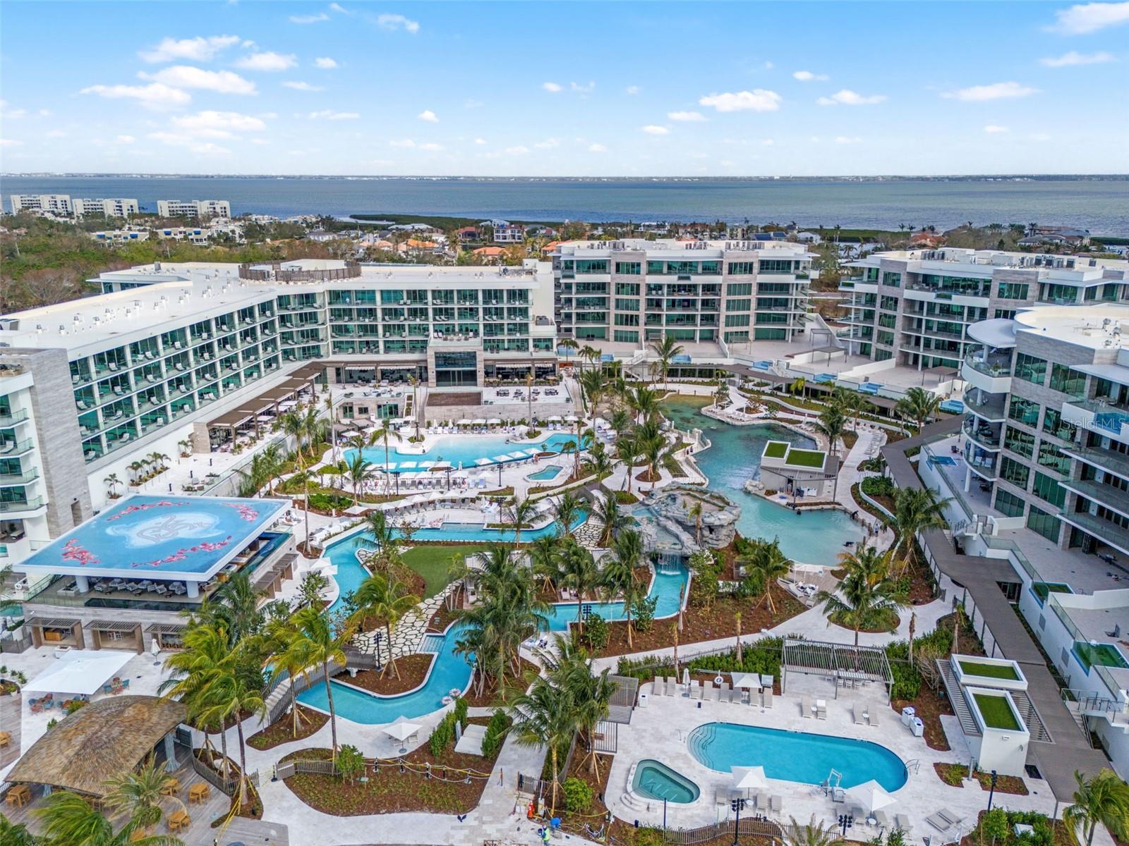 The Residences at The St. Regis Longboat Key is the first branded residential community and ultra-luxe 5-star resort hotel on the Gulf of Mexico. Welcome home to the legendary services of The St. Regis with the allure of a seaside getaway on the secluded barrier island of Longboat Key, FL. Beautifully appointed interiors with soaring ceilings and floor to ceiling sliding doors wrapping around the gathering room, dining room and kitchen provide views of sunrise or sunset skies. The gourmet kitchen includes Wolf and Sub-Zero appliances, including 6-burner gas cooktop, double ovens and panel ready side-by-side refrigerator/freezer. Owner’s suite is appointed with a spacious walk-in closet, frameless walk-in shower, and private W/C. Semi-Private elevator with keyless entry takes you directly from your private garage into the residence.
The Residences are nestled within the 17 acres beachfront resort on Sarasota’s most coveted barrier island. Amenities are unparalleled and include access the St. Regis Resort plus the signature St. Regis Butler and Concierge services, Resident-only pool and spa, and a Private Resident’s Clubhouse, fitness center and beachside cabanas.
Just steps away, residents can also immerse themselves in the St. Regis Longboat Key Resort including the private beach, pools with personal cabanas, family-friendly winding waterway and the exclusive saltwater lagoon wildlife experience complete with resident Aldabra tortoises. Escape to the sanctuary of our world-class oceanfront spa featuring vitality pools or one of the vibrant chef-driven dining outlets.