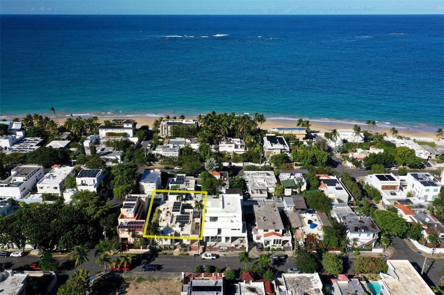 Live steps from the sand in Ocean Park, San Juan—a sun-splashed residence showcasing unique, modern architecture and warm natural finishes. Walls of windows and skylights bathe the open living and dining areas in abundant light, while custom millwork and a sculptural façade create a one-of-a-kind presence. The kitchen pairs stone accents with stainless appliances and an eat-in layout—perfect for easy gatherings before a beach day.

Designed for seamless indoor–outdoor living, wide doors open to a private courtyard with pool and spa, covered terrace, and service bar for effortless entertaining. Bedrooms are spacious and serene, offering retreat-like comfort. Everyday peace of mind comes with a full-house generator, cistern, and 24-hour community security.

In one of San Juan’s most sought-after coastal neighborhoods, you’re truly steps from the beach and minutes to cafés, restaurants, and vibrant city life—coastal style, comfort, and convenience in perfect balance.
