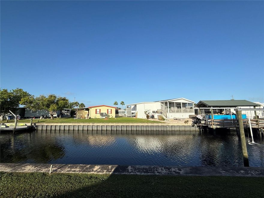 WATERFRONT Opportunity in Caribbean Isles Residential Cooperative – Dreaming of life on the water? This affordable canal-front property, in the highly sought-after Caribbean Isles Residential Cooperative, offers the perfect opportunity to create your ideal Florida retreat. Whether you choose to renovate the existing home or replace it with a brand-new manufactured or mobile home, the possibilities are endless! Situated in a 55+ resort-style, gated community, this property is priced right—barely higher than the value of the share/lot alone! - yet a new HVAC system was installed in April. With NO LOT RENT or CDD fees, your monthly maintenance cost is an ultra-low $242, giving you access to a wealth of amenities and waterfront living at an unbeatable price. Step outside, and you'll find your own backyard canal access, where you can add a private dock and set sail to Tampa Bay and the Gulf of Mexico. No dock yet? No problem! The community offers an on-site boat storage lot for only $120–$250 a YEAR—an incredible value for boating enthusiasts. But the perks don’t stop at the water’s edge. Caribbean Isles is a pet-friendly, golf-cart-friendly community with an active social scene. Enjoy a heated pool, shuffleboard and bocce courts, a clubhouse with a library, craft and game rooms, and a packed calendar of dinners, dances, and community events. Plus, with on-site professional management, you can relax knowing everything is well taken care of. This is your chance to own a piece of paradise and become a voting member of this vibrant resident-owned cooperative community.