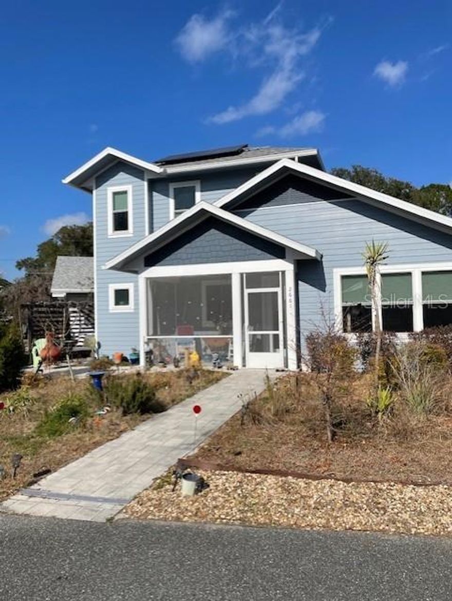 Under contract-accepting backup offers. Welcome to Gainesville's thriving Cohousing community! This bright, contemporary home's features include an open floor plan, cathedral ceilings throughout, great natural light, large kitchen island with quartz countertops, polished concrete floors, metal roof and solar panels with backup batteries.  Spacious primary bedroom has twin closets and ensuite with walk-in shower.  The 2nd bedroom is adjacent to a guest bath with tub/shower.  The kitchen adjoins a spacious living area.  There is a large studio/flex space at the back which could be converted to a 3rd bedroom.  The screened-in porch and 3 patios allow full enjoyment of outdoor living.  Information about cohousing and this specific community is attached and a community tour/orientation is easily arranged.  The home has been gently occupied since its 2019 construction.  Low energy costs verified by available records.  Plan to see it today!