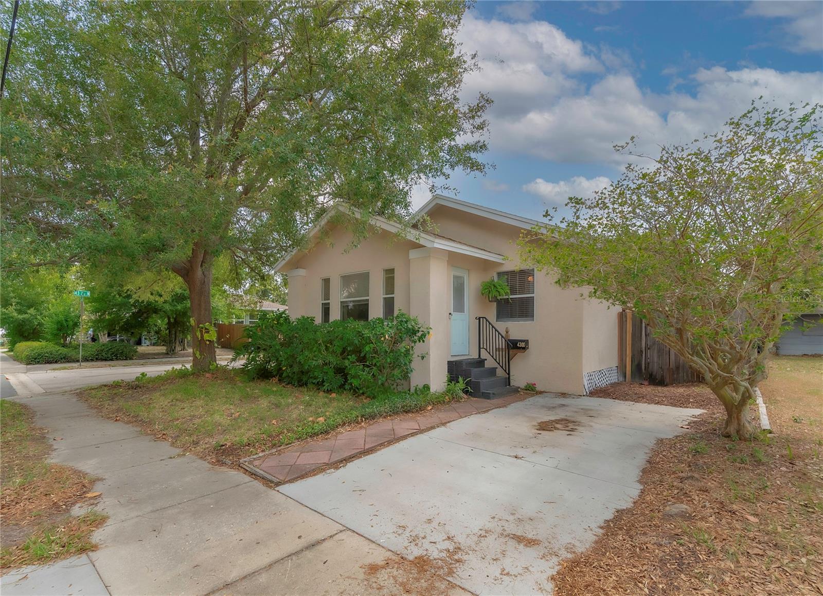 Back on the Market!! Adorable bungalow nestled on a tree-shaded corner lot in a quiet neighborhood in North St. Pete. You'll love the charming original features such as, beautiful wood floors, large baseboards, and curved archway. You'll appreciate the home's modern updates and touches including; kitchen with granite countertops, wood cabinets, stainless steel GE appliances, and waterproof vinyl flooring, new water heater (June 2023), re-piped potable water from Service (meter) to fixtures (June 2023), new ductwork in 2021, driveway replaced 2022, newer windows (2010), updated bathroom with ceramic tile floor, deep tub with shower, tiled shower walls, pedestal sink, and extra storage. This wonderful home also boasts; master bedroom with walk-in closet/dressing area, good-sized guest bedroom, inside laundry with stackable washer/dryer, office, ceiling fans, and crown molding. The fenced backyard is a welcome oasis with new sod recently planted, pavered patio perfect for lounging or outdoor dining, lovely vegetation and lemon and key lime trees. Conveniently located to Kiwanis Park, interstate access, shopping and restaurants.