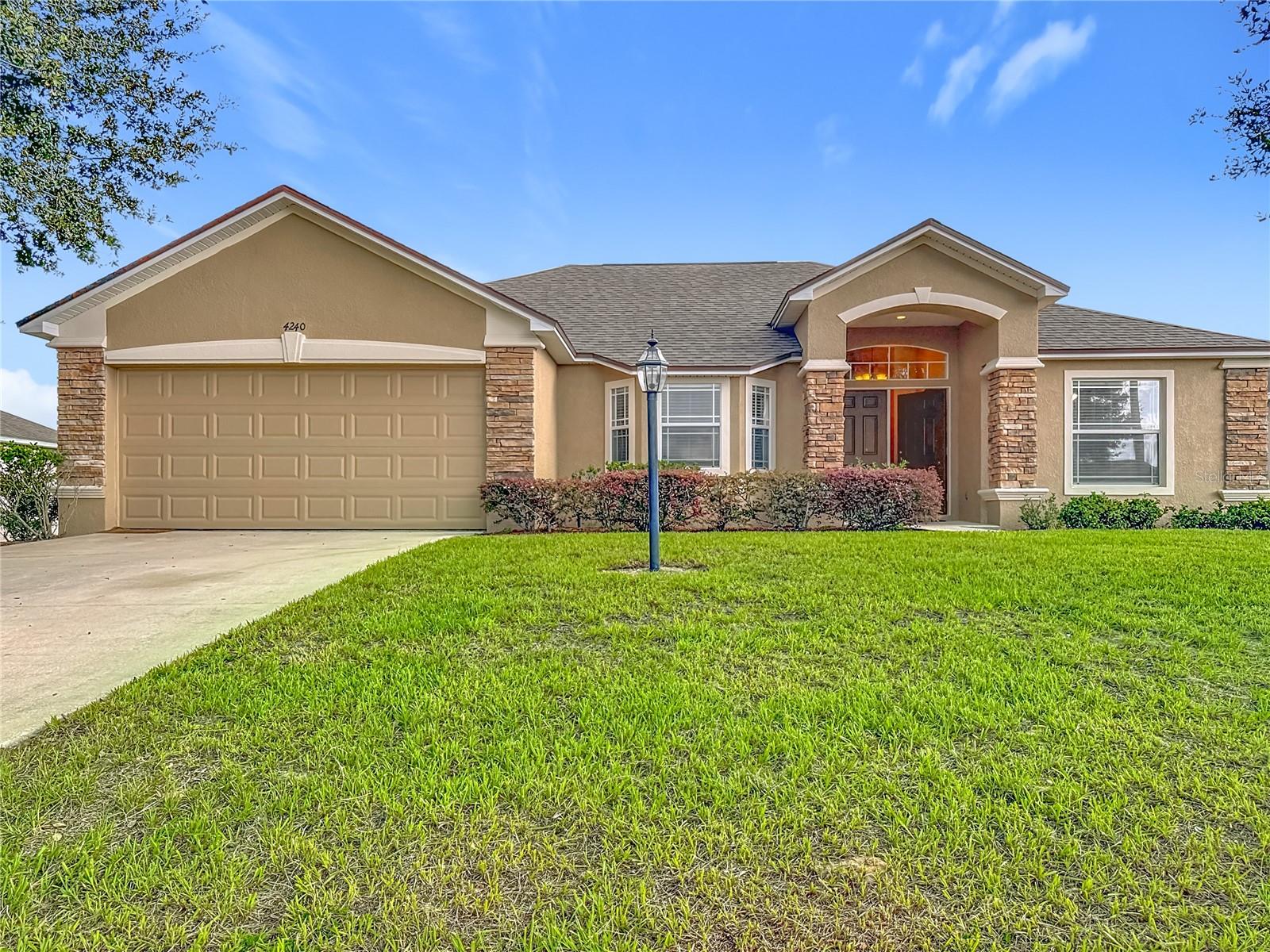 Moving Ready! Do not miss seeing this beautiful home with a new roof and new lawn installed. This model is The Roanoke. As you walk through the door to the foyer, on the left is your kitchen with vaulted ceilings plus a breakfast nook and on the right a nice-sized dining room. Walk straight to the extended Great Room 18.8x23.4, which in this particular Model is an upgrade. To the left of the Great Room are two bedrooms with the second bathroom. To the right is a nice size Master Suite with Tray ceiling and crown molding and also a his and hers walk in closets plus the Master bath with a jacuzzi/jet and a separate walking shower. The kitchen has a breakfast nook and a pantry. From the Great room you can walk through the sliding doors to the lanai, which is a decent size to relax after a busy day at work. There is also a playground in the community.