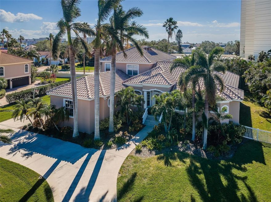 RESTING ON A QUIET CUL DE SAC, WITH A BEAUTIFUL CURB APPEAL, LARGE CIRCULAR DRIVEWAY AND TOWERING ROYAL PALMS, THIS IMPRESSIVE 5 BEDROOM, 3 ½ BATH, 4948 TOTAL SQFT (UNDER ROOF) RESIDENCE OFFER TREMENDOUS FEXIBILITY AND A WONDERFUL LIVING EXPERIENCE WITHIN PINELLAS COUNTY’S ONLY GATED BOATING, GOLF AND TENNIS COMMUNITY.  Beyond its attractive covered entry, you’ll discover rich crown trim finishes, lovely driftwood-style flooring and an expansive split-bedroom floor plan.  Open dining/multi-purpose great room overlooks the back yard and transitions to a sumptuous kitchen with fine maple cabinetry, granite surfaces, multi-level breakfast bar, stainless steel appliances, walk-in pantry and matching butler’s pantry with separate wine and beverage centers.  A double door entry opens to an owner’s bedroom featuring a large bedroom, two sizable walk-in closets, and a sitting area that opens to the back yard lanai.  The owner’s bath is an elegant retreat, with two wide vanities, a large cosmetics sitting area, a spacious dual entry shower, and private rest room.  Den/fitness room is complemented by a dedicated office.  First level guest bedroom and full guest bath.  Upstairs you’ll find a huge family room/entertainment and media center, two spacious bedrooms and full bath with walk-in glass shower enclosure.  The home offers a large indoor laundry with built in sink and extensive cabinetry and counter space.  Living room opens to a 330+ sqft covered deck with half bath and a spacious private back yard.  Home has solar electric panels, plantation shutters, 3-car garage, PVC fencing and lots of parking space.  The Pasadena Yacht and Country Club’s superior amenities including golf, tennis, fitness centers, marina, restaurant, community pool and clubhouse.  Avoid the extensive country club wait list by purchasing this most pleasing home.  Dimensions are estimates, buyer to verify dimensions. Flood insurance is under $800 per year. Assumable.