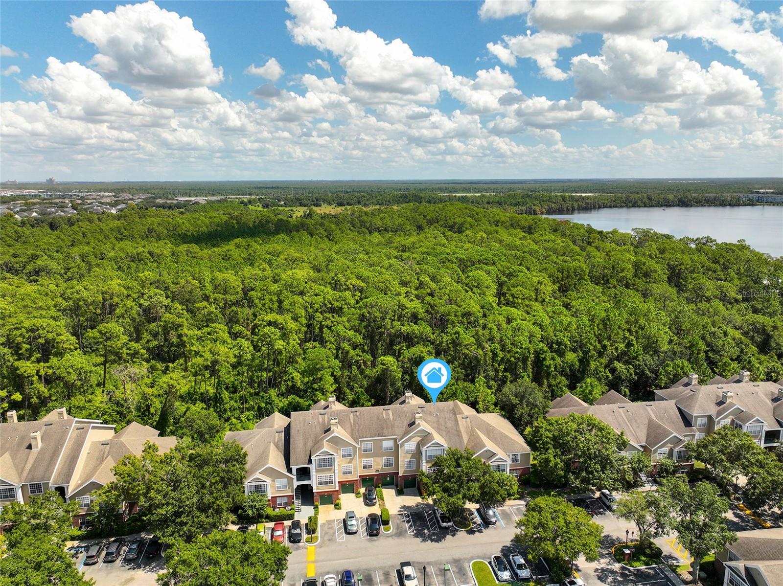 WATCH the Video/Virtual Tour to SEE MORE! Welcome to this MOVE-IN READY 2nd Floor condo with a LARGE SCREENED-IN PATIO BALCONY and a private TREE VIEW. It’s right next to LAKE BRYAN, where BUENA VISTA WATERSPORTS offers JET SKIING, WAKEBOARDING, KAYAKING, PADDLEBOARDS, TUBING, and PONTOON BOAT RENTALS—a true Florida lifestyle experience. Inside, the unit features an OPEN LIVING CONCEPT where the KITCHEN overlooks the living area and flows seamlessly into a spacious dining area. Updates include GRANITE COUNTERTOPS in both the KITCHEN and BATHROOMS, WOOD FLOORS that add warmth and style, plus the HVAC and WATER HEATER both replaced in 2020. TREE VIEWS FROM EVERY WINDOW! The PRIMARY BEDROOM offers a private ENSUITE BATHROOM, a large WALK-IN CLOSET, and abundant NATURAL LIGHT. BEDROOM #2 is equally spacious, with a bright window and convenient access to the second full bathroom. The location of this unit is unbeatable—directly across from the CLUBHOUSE, FITNESS CENTER, TENNIS COURTS, and COMMUNITY POOL. The CONDO ASSOCIATION includes ROOF REPLACEMENT, EXTERIOR MAINTENANCE, LAWN CARE, PEST CONTROL, and even your MONTHLY WATER BILL! The CLUBHOUSE also offers a KITCHEN, BAR AREA, POOL TABLE, PING PONG, and a cozy lounge with SOFAS AND TV and is available for reservations by residents. You’re just 3 MILES TO DISNEY SPRINGS, 5 MILES TO EPCOT, HOLLYWOOD STUDIOS, and DISNEY'S ANIMAL KINGDOM, and only 1 MILE TO ORLANDO VINELAND PREMIUM OUTLETS. SEE MORE in the custom VIDEO/VIRTUAL TOUR!