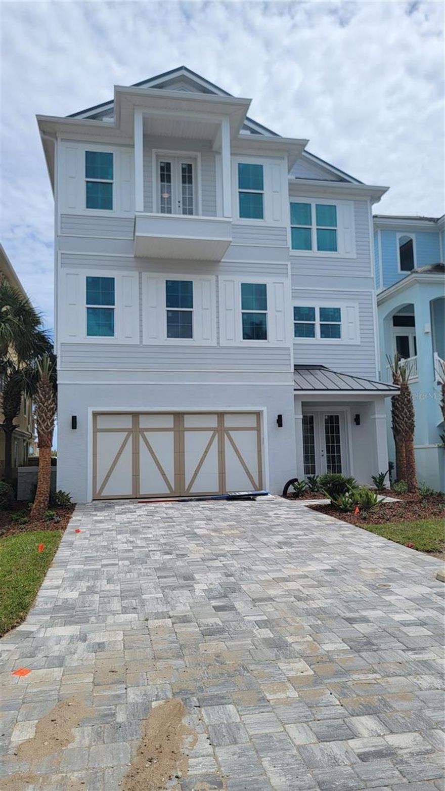 Under Construction. Brand-new oceanfront home in Cinnamon Beach! Why wait years to build when you can own a new house on the beach right now, without all the hassle of the design and construction process? This incredible beachfront residence offers breathtaking views of the Atlantic and dedicated boardwalk for instant access to the beach. All three luxurious living levels are serviced by an interior elevator, so it’s a breeze to go up and down with groceries or luggage. The ground level offers 2 spacious guest bedrooms, a game room for your friends and family to gather, and access to the patio area. Lounge all day in the sun, or use your private walkway (shared with one neighbor) to get your toes in the sand in no time! The second floor is the main living level, and features an open-concept living area, dining space with a view, gourmet kitchen and bar area for entertaining. Mesmerizing ocean views draw you to the massive 35-foot long balcony. This is an ideal spot for the whole family to gather and recharge to the sound of waves crashing in on the shore. The kitchen features a huge island with breakfast bar seating and fabulous prep space. Smell the coffee brewing in the morning, and effortlessly carry it out to the large deck to sip on while you watch the sunrise. Two additional guest suites with full bathrooms are conveniently located on this floor, as well as a powder room just off the main area. Ascend the staircase or the elevator to the 3rd floor, where you’ll find the master suite of your dreams, which runs the full width of the house on the ocean. Wake each morning to the sun coming up over the Atlantic. Open up the sliders to your massive balcony and let the sounds of the sea rock you to sleep each night. Giant walk-in shower and soaking tub. You’ll never want to leave your room! There is 2nd master suite on the west side of the floor, ideal for visiting friend or family members that deserve spacious accommodations at your oceanfront estate. Cinnamon Beach is a privately gated neighborhood within the exclusive community of Ocean Hammock, a tranquil, coastal gem located in Palm Coast, Florida, just 20 minutes south of St. Augustine, 30 minutes north of Daytona Beach and 75 minutes east of Orlando. Featuring 2.5 miles of pristine cinnamon-toned beach, the community features a harmonious blend of Key West-styled homes. Community amenities include lakeside clubhouse with “zero-entry” pool for the little ones, water slide, fitness center, game room, bar/grille, lounge, and oceanfront pool complex with hot tub and access to the beach. Construction expected to be completed in late Summer 2023. An unprecedented opportunity to own a NEW oceanfront home in Cinnamon Beach! This one won’t last- don’t delay!