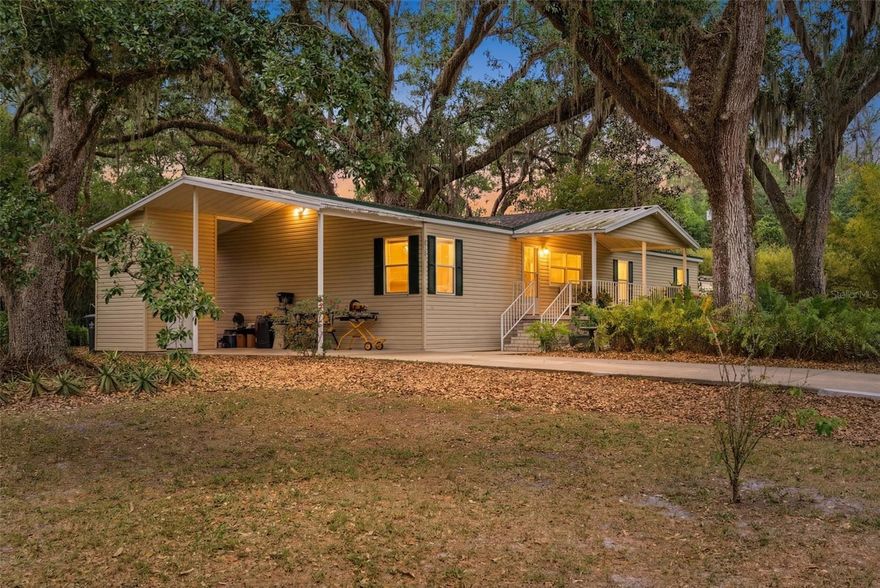 ONE-OF-A-KIND HOME, CONVENIENTLY LOCATED IN A QUAINT NEIGHBORHOOD. Inside this hidden gem of a neighborhood, oak-canopied streets are quiet, the lots are generous, and the outside world feels miles away; however, it offers quick access to I-75, I-4 & US-301, making it a desirable location. Half an acre shaded by a grandfather oak and 14+ mature oaks, bamboo privacy hedges, and professional tropical landscaping sets the stage. This home was built to last with 6" exterior studs and on the roof, lifetime architectural shingles with rubberized underlayment. But it's the kitchen that steals the show: custom island with prep sink, pull-out drawers, appliance wall, and recessed storage. Historical materials throughout, including 175-year-old tavern wood, 1800s pecky cypress barn door, 150-year-old chestnut breakfast bar, and imported 1930s English stained glass. The primary suite connects to a utility room and high-density pantry through what feels like a secret passageway. Brand new primary bath with soaking tub and dual-head shower. App-controlled HVAC, new paver patio, 12x30 storage building, well with 120-gallon tank (pump replaced within the last 10 years), and septic with no monthly water or sewer bills. This isn't a flip. It's a forever home, and it shows in every detail.