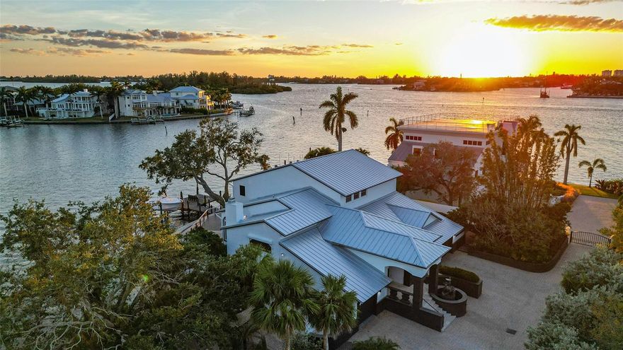 Unbelievable opportunity to own this exquisite bay front home at an extraordinary value. The best boating access and location that Sarasota has to offer with being minutes away from #1 beach in America "Siesta Key", downtown/shopping, and A+ schools. Surrender to the allure of unsurpassed waterfront splendor at this fully remodeled sanctuary, where design and refined living meld to perfection. Peaceful and quiet with tons of privacy, cradled within your own private gate and half-acre of manicured grounds located in the prominent West of Trail area, this home brings you into an enclave of classic sophistication, crowned with a new sleek metal roof (2022) and Hurricane impact windows that enhances its architectural grace.

Located in the heart of Sarasota's most desired boating waters, the property hosts a state-of-the-art dock, ready to embrace a fleet of vessels, anchored by a newer robust 10,000lb boat lift  with newer seawall and room to add another boat lift . This is a mariner's paradise, heightened by the residence's elevated stance, showcasing not just stunning views but also the practical benefit of lower flood insurance premiums ($2100 per year). Commanding 160 feet of pristine waterfront and half an acre, this haven affords rapid access to the open ocean, framing every turn with inspiring water views that dance across all the rooms. Within, a world of luxury unfolds,  The residence, beautifully remodeled, is designed for comfort and elegance, with an elevator providing effortless transition through the living spaces, and a three-car garage presenting a grand stage for automotive aficionados.

Every detail is meticulously curated to offer a living experience that is as inviting as it is extraordinary, the moment you walk in you will notice the high ceilings and stunning views of the bay, with a contemporary kitchen has been remodeled with stone counter tops, custom coffee machine, high end cabinets, & high-end stainless-steel appliances; a Sub Zero refrigerator, double oven, and wine cooler. The massive island has waterfall quartzite countertops with views of the beautiful bay. Custom double pull-out pantries and plenty of additional storage space. Walk into the owner's suite and grasp the most breathtaking views of the water with sunset views year round, also highlighted by one of the most magnificent custom walk-in closets you will ever find in a home. Top it off with your incredible master bathroom that gives you the resort luxury feel. 

Outdoor leisure is set against the backdrop of Florida's radiant sun, with a setting that promises idyllic days in a private waterfront retreat combined with a 45 foot heated salt water pool and your own private "zen" garden. Other improved features of this home are a generator, salt water pool, central vac, and private gate with security cameras. 

1410 Siesta Drive isn't merely a residence; it is a testament to the grandeur of coastal living, an emblem for the connoisseur who will settle for nothing less than the zenith of Sarasota's luxurious lifestyle.