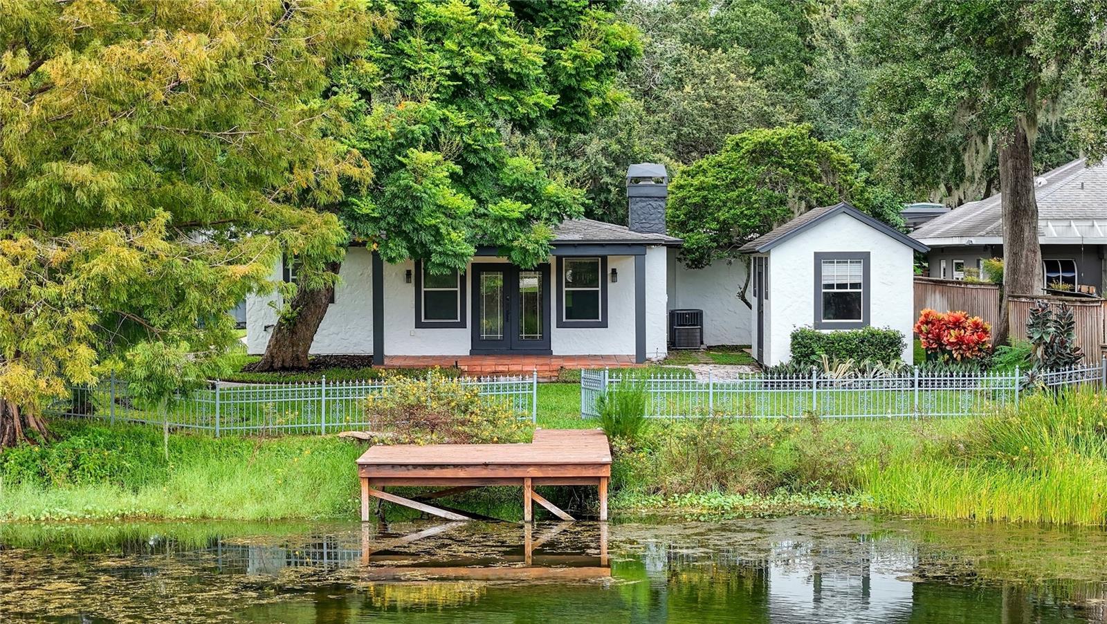 Prime location Winter Park mid-century home sits on an oversized WATERFRONT CORNER lot minutes from downtown WP, Audubon Park, and Baldwin Park. Enjoy access to top public and private schools. Step into nearly 2,200 square feet of beautifully maintained living space. Your home features a thoughtful split-bedroom floor-plan with formal living and dining rooms, a spacious family room with wood-burning fireplace, and elegant touches like hardwood floors, crown molding, and detailed woodwork throughout. The updated kitchen is a standout with granite countertops, a glass tile backsplash, stainless steel appliances and a versatile dry bar/coffee station. Large windows and French doors in the family room fill the home with natural light and open to a covered patio with sweeping views of the manicured backyard and tranquil lake. The primary suite offers a peaceful retreat with a walk-in closet and private en suite bath, while two generously sized guest rooms share a stylish hall bath featuring a vintage clawfoot tub. With 70 feet of waterfront, a newer dock, and space for kayaks or paddle-boards, this home delivers year-round outdoor living. An outdoor private sauna for your enjoyment and large storage shed offers flexible use for a workshop, studio, or extra gear. Also equipped with brand new HVAC system and Reverse Osmosis Whole-Home Water Filtration System. Rare opportunity to lease a low-maintenance lakefront residence in one of Orlando’s most desirable neighborhoods. Zoned for Audubon K-8 and Winter Park High. Move in just in time for the school year! Schedule your private tour today.