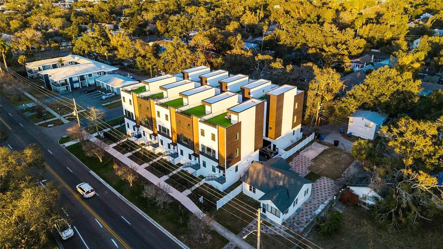 If views, privacy, and presence matter — this is the one. Not just a townhome—this is a vantage point. Welcome to Unit 5 at 4th Street Gardens, a private gated community in Historic Old Southeast, positioned on the edge of Downtown St. Petersburg. This premier corner residence holds one of the most desirable positions in the building, offering the best panoramic views and enhancing the sense of openness, light, and connection to its surroundings. Fully completed, this modern home offers approximately 2,280 sq ft across three levels, plus an expansive rooftop terrace of nearly 1,000 sq ft—ideal for entertaining while enjoying breathtaking sunrise and sunset views. Features include a Modern kitchen, high ceilings, three private en-suite bedrooms with a spa-inspired owner’s suite, a private fenced yard, an oversized garage with 16’ ceilings, and elevated high-and-dry construction; the property did not experience flooding during recent storms. Additional highlights include a 20-year no-dollar-limit roof warranty and a 2-10 Home Buyers Warranty. Located just minutes from the university, Bayfront Hospital, Central Avenue dining and entertainment, waterfront parks, kayaking, and all Downtown St. Petersburg amenities.