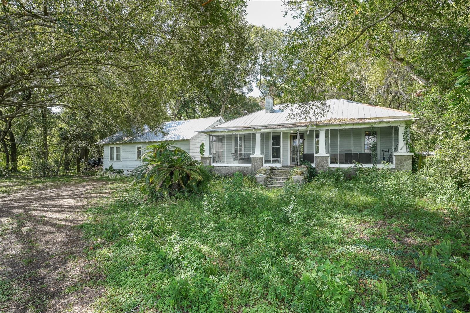 An exceptional opportunity awaits on this expansive three-acre property. The inviting residence features four bedrooms, two baths, a separate office, and generously sized rooms adorned with original hardwood floors. The large lot offers significant potential for future expansion, allowing you to create the home of your dreams. Additional amenities include a robust metal roof, a modern ductless air conditioning system and a versatile workshop.
