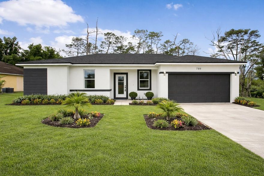 One or more photo(s) has been virtually staged. Brand new construction in Deltona! One or more photos have been virtually staged. 

This beautifully designed home features a modern open-concept layout with high ceilings, recessed lighting, and durable luxury vinyl plank flooring throughout. The spacious living and dining areas flow seamlessly into a well-appointed kitchen complete with granite countertops, stainless steel appliances, shaker cabinets, and a large center island.

The split-bedroom floor plan offers added privacy and functionality. The primary suite includes a walk-in closet and an en-suite bathroom with dual vanities and a tiled walk-in shower. Additional bedrooms are generously sized with ample closet space.

Sliding glass doors provide natural light and lead to a large backyard situated on a 0.22-acre lot with no rear neighbors and wooded views.

This property offers flexible use options, subject to local regulations. This home may be enjoyed as a primary residence or short term/long term rental.

Conveniently located approximately 40 minutes from nearby beaches and close to parks, lakes, and outdoor recreation throughout Volusia County.