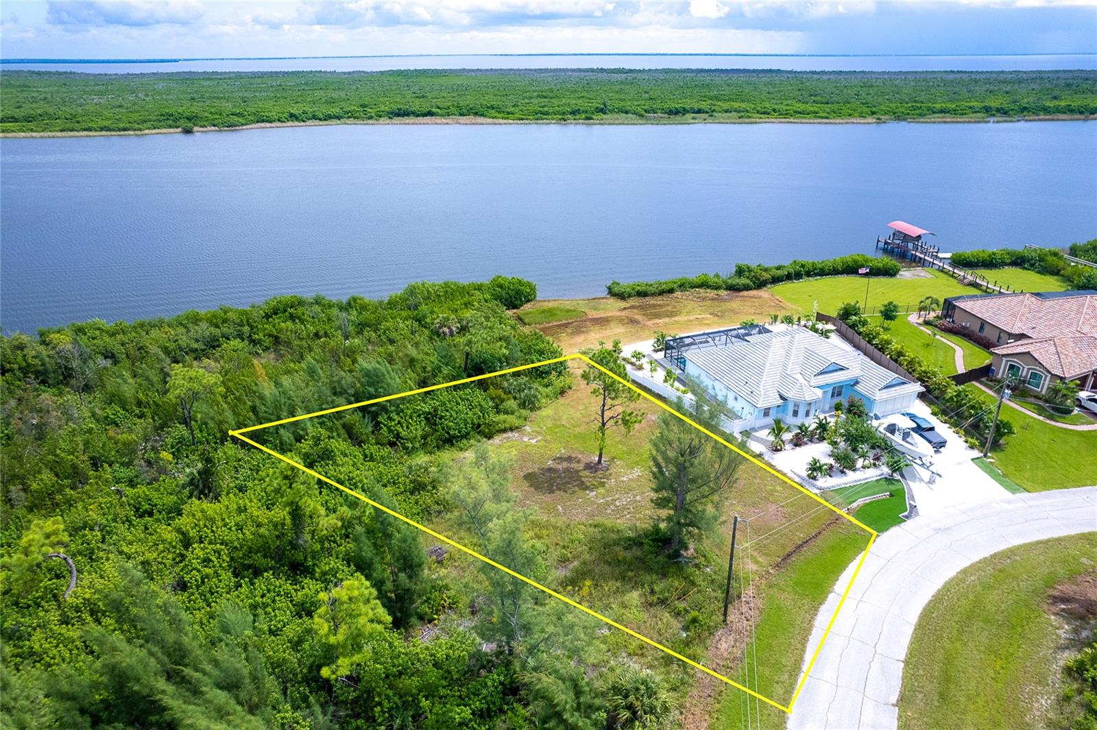 Imagine waking up to wide-open lagoon views, coffee in hand, while sailboats slip quietly past your backyard. This oversized waterfront lot in Section 94 of South Gulf Cove is more than just land, it's the beginning of your dream home story. Tucked along the Interceptor Lagoon with no fixed bridges out to Charlotte Harbor and the Gulf, you'll enjoy peace, privacy, and endless water adventures. Neighboring homes already show the high standard of the community, with beautiful residences and private docks in place. And here's the best part: the current owner is a building contractor who can build to suit, with conceptual drawings and plans already designed to take full advantage of these incredible views. South Gulf Cove puts you minutes from beaches, golf, shopping, dining, and those famous Southwest Florida sunsets are right outside your door. This isn't just a lot, it's your chance to live the waterfront life you've always imagined.