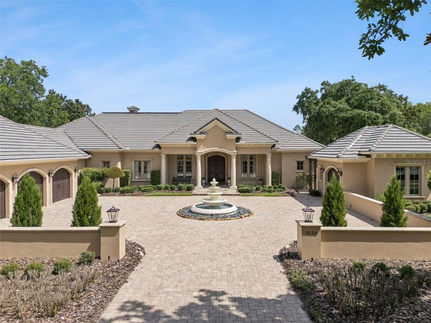 This is the home that you have been dreaming of! From the welcoming paved courtyard into the voluminous foyer with expansive views of a scenic pond through a wall of windows, this home presents luxury at its finest.  The extreme care with which the property has been maintained is obvious throughout.  As a custom designed home, it has exquisite finishes and hand crafted woodwork and cabinetry.  9225 Bevington Lane is situated on nearly a full acre lot, has professionally designed landscaping, with no development across the street and is located on a peaceful private pond which provides exceptional privacy and open natural views.  With 5,700 square feet of elegantly appointed interior living space, high ceilings and wall to wall windows, you will experience the apex of the Florida lifestyle.  It has 4 spacious bedrooms, 4 full bathrooms and 2 half baths, all situated in a single story layout.  The lanai has over 1,000 square feet of covered poolside living area with full outdoor kitchen and dining area.  The home offers the highest quality finishes throughout with travertine and hardwood floors, tile roof, attached 1,470 square foot 3 car garage, an additional detached single car garage and a private oversized pool with an expansive paver deck. Each bedroom has its own bathroom and walk-in closets with custom cabinetry.  This residence features extensive amenities, an oversized laundry room with two washers and two dryers, a game room, technology ready wiring throughout, many unique
accessories and tailored design elements. The home offers so many unique features including cast concrete columns exterior and interior, all Anderson windows and doors double insulated, two fireplaces, a Generac generator 40KW that can fully power the entire home, a security system and a full irrigation system are just to name a few. This beautiful Lake Nona waterfront home is truly move-in-ready for its new owner!!!