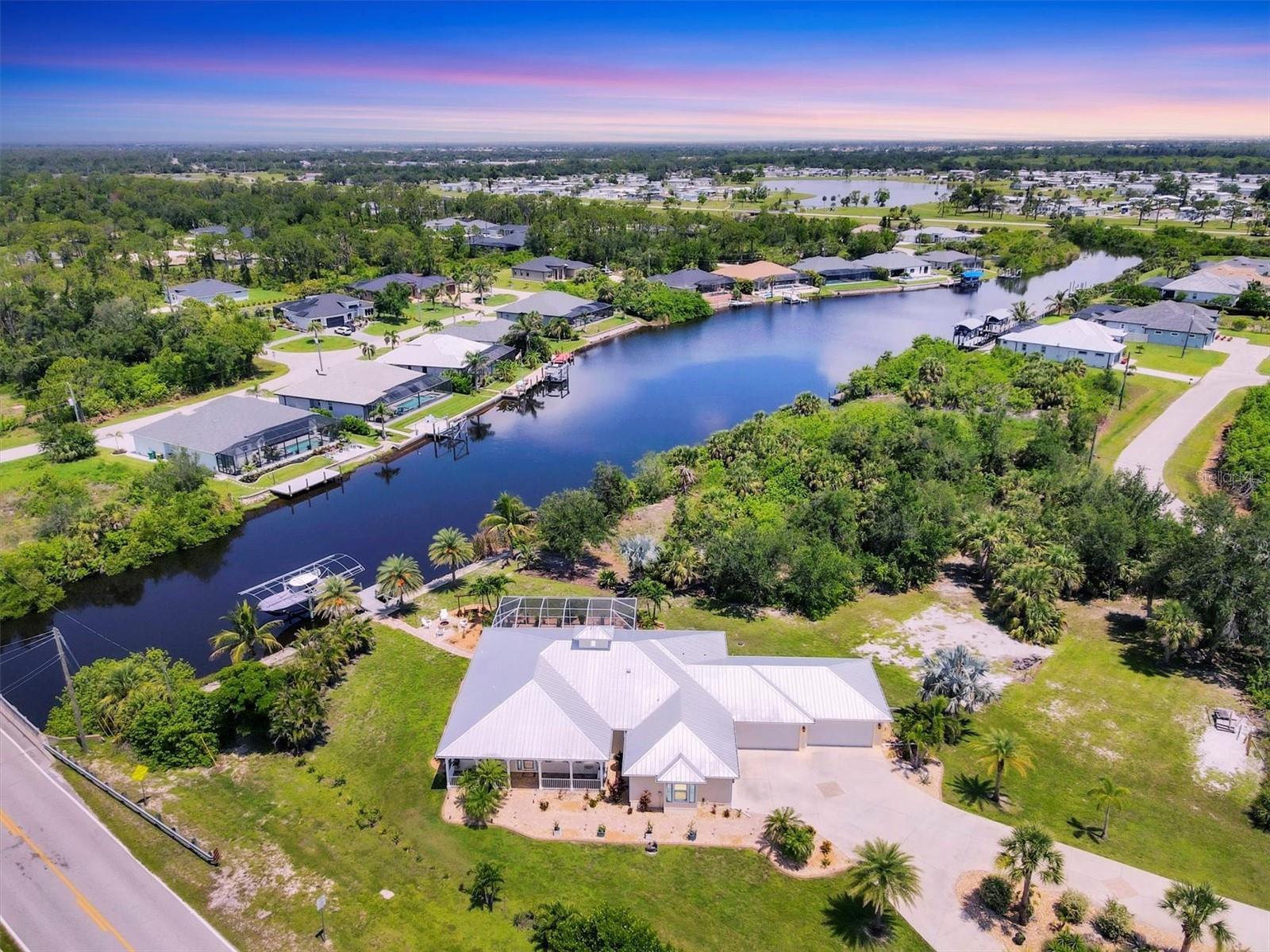 YOUR WATERFRONT "FLORIDA DREAM HOME" AWAITS !!! STUNNING and elegantly appointed KEY WEST style pool/spa Home with a COASTAL FLAIR has 3 BEDROOMS and 3 FULL BATHS. This Home was CUSTOM Built by a quality area builder in 2016 on an OVERSIZED corner lot thats approx. 1.55 acres (67,303 sqft) with a CIRCULAR drive and a 6 CAR GARAGE. Located in the WATERFRONT BOATING community of SOUTH GULF COVE. A BOATERS DREAM with direct access to the GULF of MEXICO and SURROUNDING ISLANDS and Beautiful SANDY BEACHES. This home is for the distinguished buyer and features many UPGRADES... ALL Doors and Windows are IMPACT GLASS, SPRAY FOAM INSULATION makes this home Energy efficient, Beautiful Architectural design elements, Niches and Plant shelves, Ample Closet space, Pocket Doors, Plantation Shutters throughout, Plank and TILE FLOORING, Ceiling Fans, Beautiful Light Fixtures, Tray Ceilings with CROWN MOLDING, Floor plan boasts a spacious OPEN layout. Great Room with Sliders to Lanai, Tray Ceiling, crown molding and ceiling fan. Nice Breakfast Nook. Elegant Kitchen Boasts 42"Cabinetry with Crown Molding, soft close drawers and doors, upgraded GRANITE countertops, Double Sink, PENDANT LIGHTING, Recessed Lights, Breakfast Bar, STAINLESS steel appliances to include Refrigerator, Range, Microwave and Dishwasher and a Closet pantry. Beautiful Dining Room, Laundry room includes WASHER and DRYER and has metal shelving. Primary suite has FRENCH DOORS with private access to the lanai with pool and water views, plank flooring, tray ceilings with crown molding and an exceptionally LARGE WALK-IN CLOSET, Beautiful bath with DUAL VANITIES, built-in cabinetry, GRANITE countertops, TILED SHOWER with seating and 2 LINEN CLOSETS. There are 2 Guest Bedrooms, Guest Bath has tub and is nicely tiled. third full bath serves as pool bath. Outside Enjoy the BRICK PAVER spacious Lanai that features a HEATED salt water POOL and SPA with OUTDOOR GRILL area. This home has 120 ft. of RipRap Waterfront with a 24X8 Trex BOAT DOCK with 12K LIFT, Electric and Water. MORE FEATURES include a METAL ROOF, Mature Landscaping with Beautiful PALM TREES, an IRRIGATION system that feeds from canal. A 6 CAR GARAGE with over 1,600 sq.ft.for all your cars and toys with epoxy coated flooring, pull down attic stairs for more storage, front accent shutters, OUTDOOR SWING, FIRE PIT, Spray Foam insulation for energy efficiency and you can Relax on the covered FRONT PORCH...AND SO MUCH MORE!!! South Gulf Cove is only Minutes away from SOUTHWEST FLORIDA BEACHES in BOCA GRANDE and MANASOTA KEY. Community offers a BOAT RAMP, Several Parks and Marinas. With GOLF COURSES, World Class Fishing, Shopping and Great Restaurants only minutes away!!! This exceptional Home has been Meticulously Maintained. With over 1.55 ACRES you will have room to park your RV too. EXPERIENCE the COASTAL FLORIDA LIFESTYLE !!