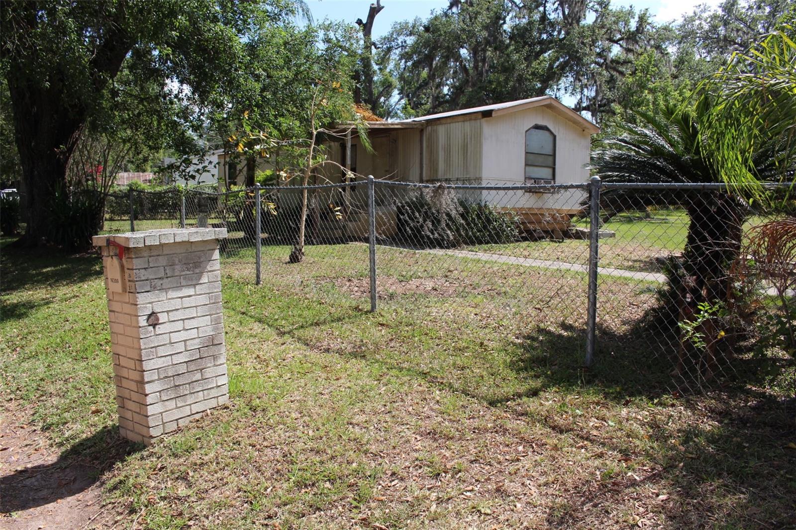 Imagine a peaceful just under a one-acre property nestled in the countryside, surrounded by open skies and the gentle sounds of nature. A gravel driveway leads to a charming mobile. The land is mostly flat with a gentle slope, covered in a mix of soft grass and wildflowers that sway in the breeze. Mature trees dot the property-oak, and maybe plant you a few fruit trees-to offer shade and character. There's room for a few chickens or goats if you're into homesteading. This property offers all the charm, quiet, and self-sufficiency of true country living.