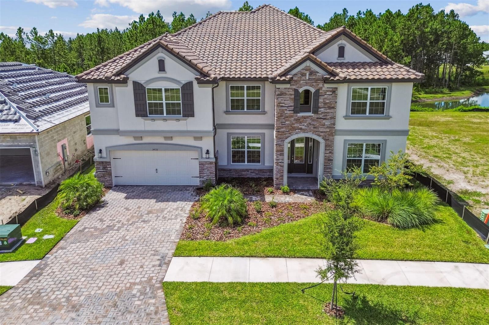 New construction home by M/I Homes in Shortgrass at Two Rivers. Popular Grandsail III floorplan, elevation D.
Experience the beauty of new construction at 34526 Alger Point Zephyrhills, FL. This exceptional home, built by M/I Homes, offers 5,452 square feet of thoughtfully designed living space.
This beautiful new-build home features:
6 spacious bedrooms and a den
4 full bathrooms for optimal convenience
Game room and media room
47' x 8' lanai and balcony
New construction with contemporary design elements
This stunning 6-bedroom, 4-bathroom home provides ample space for family living and entertaining. The downstairs owner's bedroom offers privacy and accessibility, while the additional bedrooms provide comfortable accommodations for family members or guests.
The heart of this home is its well-designed open-concept living space, creating a natural flow between kitchen, dining, and living areas. This thoughtful design allows for easy conversation and connection while maintaining distinct functional zones. Your gourmet kitchen easily accesses the formal dining room through the butler's pantry.
As a new construction home, everything from the foundation to the fixtures is brand new, meaning you'll enjoy the peace of mind that comes with modern building standards and materials. The craftsmanship by M/I Homes is evident in every detail, from the carefully planned layout to the quality finishes throughout.
The generous 5,452 square feet of living space offers room for everyone and everything, with versatile areas that can adapt to your lifestyle needs. Whether you're hosting large gatherings or seeking quiet spaces for work and relaxation, this home delivers.
Located in Zephyrhills, this home puts you close to area parks while maintaining a peaceful neighborhood setting. Contact us today to learn more!
*Photos shown are for representational purposes only and may not depict the actual home.