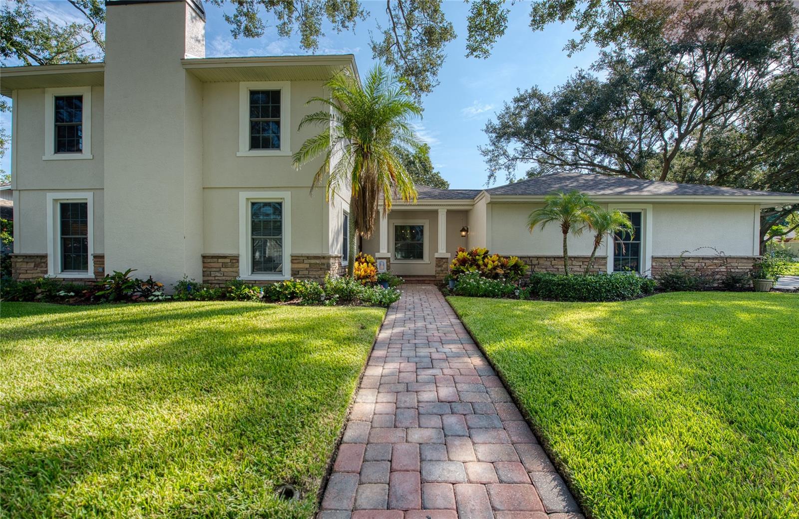 Welcome to your dream Countryside family retreat! This spectacular home is ready to nurture its next family. With 3,520 square feet of heated and cooled living space, it offers 5 spacious bedrooms, 3.5 bathrooms, and a 3-car garage. Step outside and unwind among lush native Florida foliage, serenaded by the soothing sounds of a waterfall and koi pond. A private well sustains the vibrant yard and poolside landscaping, while the pool deck—crafted from exposed shell concrete with elegant travertine edging—adds a touch of coastal charm.
The expansive kitchen and its storage are a chef’s paradise, featuring 30 feet of granite countertops, custom cherry cabinetry, a warming drawer, built-in wine cooler, and a dual-power gas/electric stove with five burners, one and a half ovens, and a convenient pot filler. Under-cabinet lighting sets a warm ambiance, and stainless-steel appliances beautifully complement the oak and ash wood flooring. Entertain effortlessly in the immense great room, complete with a custom-built entertainment center and a 73-inch Mitsubishi TV enhanced by a surround sound system. The master bathroom offers spa-like luxury with a whirlpool tub, walk-in shower, and double-sink vanity.
Practical upgrades include: Roof replaced in 2016 with Owens-Corning dimensional shingles with a transferable lifetime warranty. Downstairs AC replaced in 2024; upstairs in 2016. Rinnai tankless gas water heater replaced in 2022. Hurricane-rated Anderson sliding doors and insulated impact resistant windows provide energy efficiency and a very quiet environment, while ensuring lasting protection in this high-and-dry, no-flood-zone location. Possible owner financing.