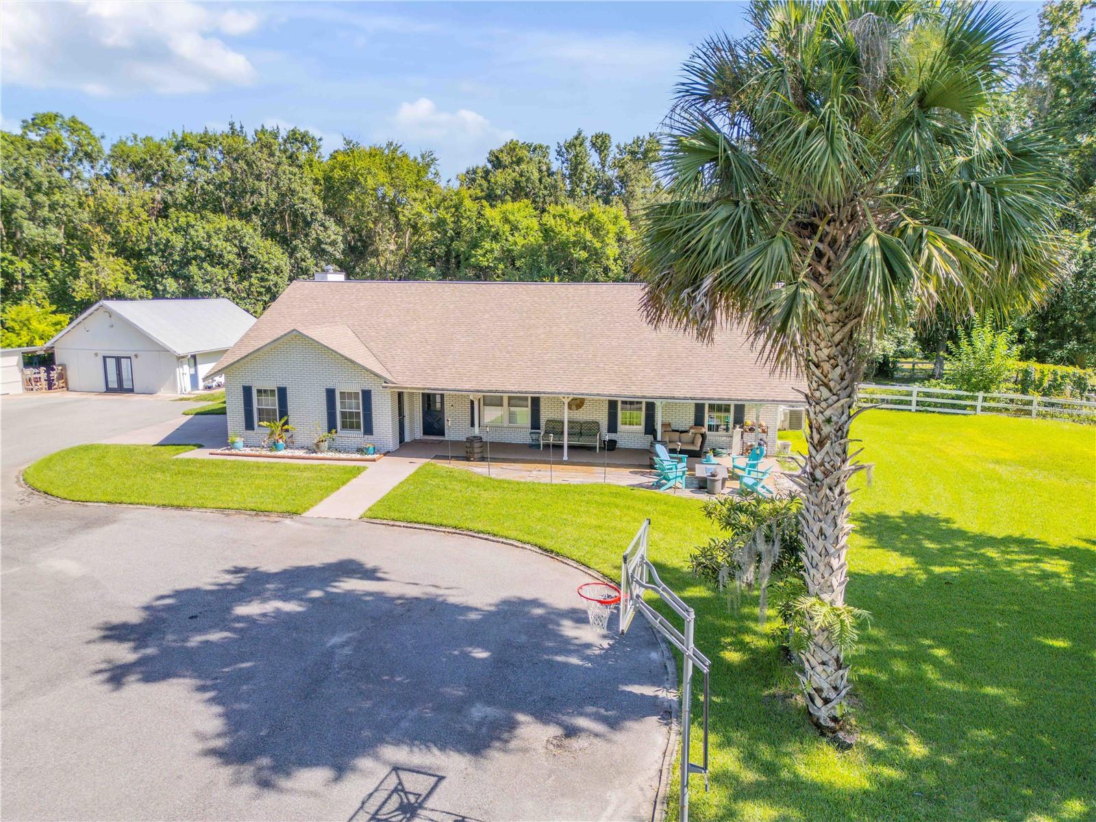 Welcome to 3080 Ragis Road – A Rare 5-Acre Retreat in the Heart of Edgewater!
Experience the perfect blend of country charm and functional living on this sprawling 5-acre estate, tucked away in the quiet serenity of Edgewater. This 3-bedroom, 2-bathroom ranch-style home offers over 2,600 sq ft of living space, plus a separate guest bungalow, multiple workshops, and horse facilities—making it ideal for multi-use living, hobbyists, or equestrian lovers.
Step inside to find vaulted ceilings, a cozy stone fireplace, and an open, airy floor plan that flows seamlessly from the spacious living area into an updated kitchen and oversized Florida room—perfect for entertaining or relaxing in comfort.
Outdoors, you'll find cross-fenced pastures, a 4-bay garage/workshop, a 24x28 air-conditioned tack room, and covered horse stalls—ready for your animals, business, or storage needs. A 25x30 RV/boat carport adds even more flexibility.
Need extra space? The detached guest quarter provides privacy and potential for rental income, with its own living area, kitchen, bedroom, and carport.
Enjoy peaceful mornings on the covered porches, spend your afternoons under shady oaks, and embrace the lifestyle this one-of-a-kind property offers—just minutes from town, yet a world away.