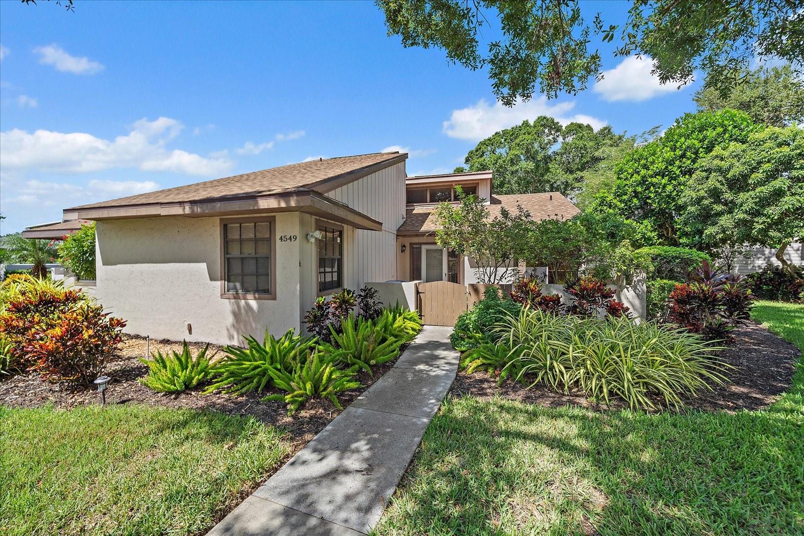 Live the Florida lifestyle in Beekman Place. This 2-bedroom, 2-bathroom condo is being sold AS-IS and offers great potential to make it your own. Inside, you’ll find vaulted ceilings that bring in plenty of natural light, a dining room with sliders to the back patio, and an eat-in kitchen with a large pantry and sliders to the front patio. The primary en-suite has already been updated with granite counters, new tile, and walk-in shower with built-in bench. The guest bathroom features a brand-new comfort-height toilet, and the guest bedroom offers two large closets. Other recent improvements include luxury vinyl plank flooring in the hall, guest bedroom, and bath, a NEW WATER HEATER (2022), and a NEW ROOF (2023). Outdoor living is a highlight here: a spacious screened back patio overlooks a serene pond with fountain—perfect for enjoying sunsets—and the front paver patio provides a welcome entry with a quaint spot for morning coffee. A large oak tree graces the front yard, adding to the setting’s charm. Beekman Place is known for its beautiful tree-canopied drive, inviting pool and hot tub area, and unbeatable location. You’ll be minutes from downtown Sarasota, the beaches, and all the dining and shopping at University Town Center. Yes, this condo could use some updates, but with its layout, setting, and community, the potential is undeniable!