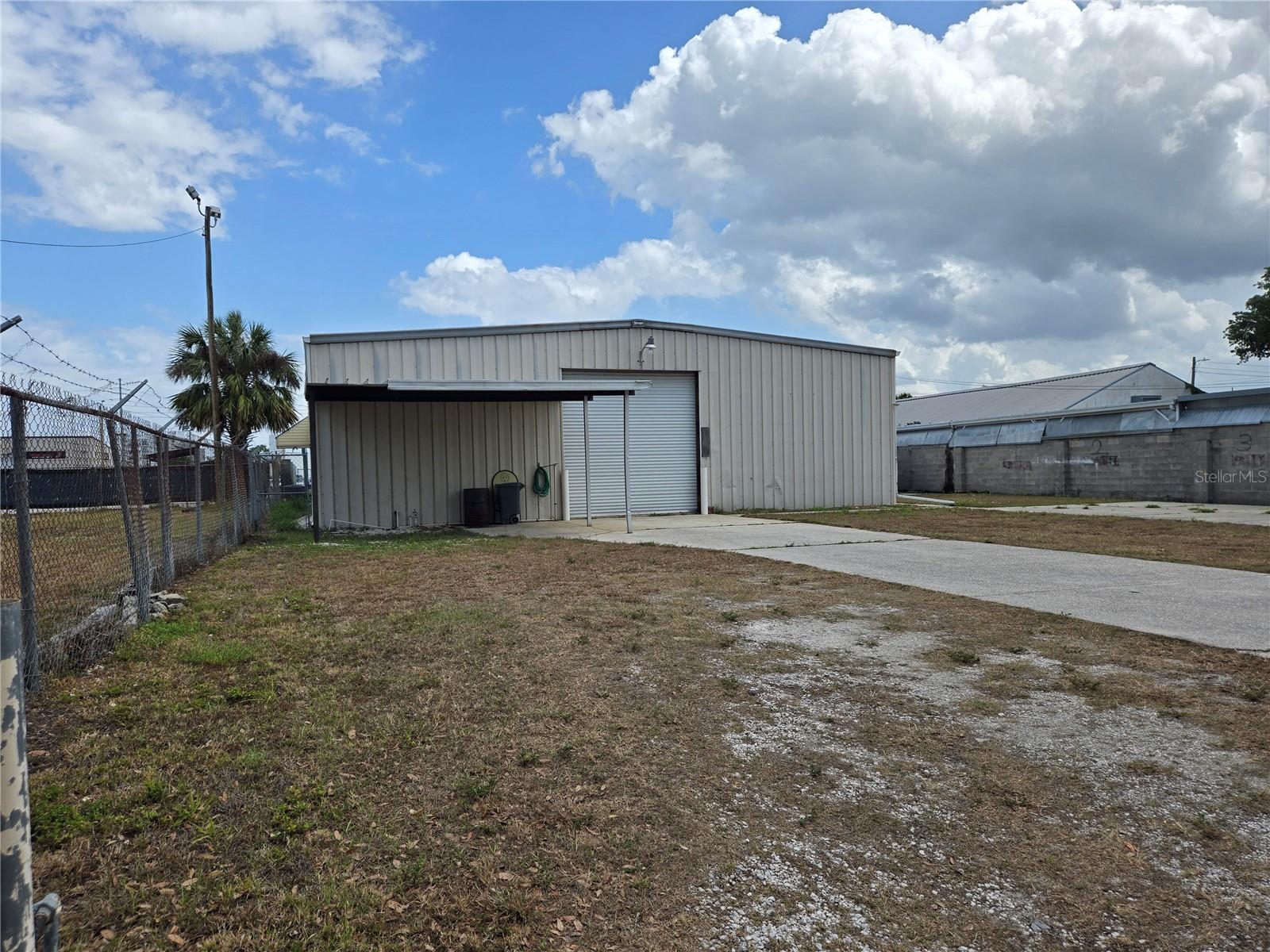 50' x 48' Warehouse storage space for lease. 12' garage door. Own private entrance, carport cover for 2 automobiles. Fenced yard convenient to downtown Winter Haven. Listing agent is owner.
