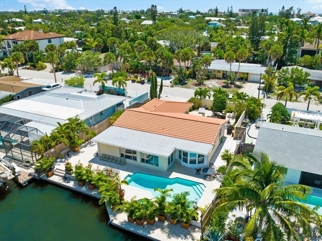 Welcome to this amazing Siesta Key vacation home! This beautiful 3 bed/2 bath canal-front beach home is ideally located just a short stroll to Siesta Key Village, with its array of shops, dining options, and entertainment. Situated on a quiet residential street, this home has so much to offer. As you enter this exquisite home, you will find original and restored terrazzo floors, wood beams with modern finishes. The beautifully updated kitchen with stainless steel appliances, wood cabinetry, comes fully stocked with ample cooking utensils, pots and pans, etc. The primary bedroom overlooks the pool area through a charming bay window, it features a king-size bed, en-suite bathroom with dual sinks and walk-in shower. The additional 2 bedrooms are beautifully furnished. Step outside to the large open pavered patio with a beautiful, heated pool and spa, and the serene canal water views from your own backyard leading to the Sarasota Intracoastal, a haven for kayaking and paddle boarding enthusiasts. This luxurious vacation home is truly one-of-a-kind and is also a short distance to the beautiful Siesta Key Beach with its sparkling turquoise waters of the Gulf of Mexico and the crystal quartz sand. The home is also ideally located for fishing, swimming, snorkeling, paddle boarding, biking, shelling, boogie boards, beach run/walk, or RELAXATION, sunbathing, picnicking, building sandcastles, sunsets, or enjoying live music, shopping, and award-winning restaurants. Looking to venture off Siesta? Enjoy an evening out in Downtown Sarasota located just 7 miles away where you will find a vibrant music scene, numerous art galleries, elegant shops and many restaurants with outdoor seating. **Note: The property has recently had some updates made, new photos will be coming soon**