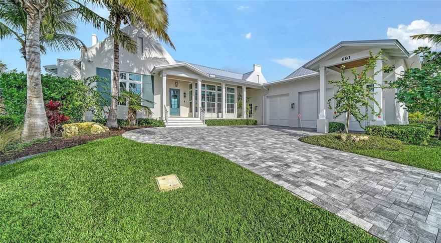 Welcome to a crisp & clean Florida ranch. Located in popular Emerald Harbor which is a bayside enclave of just 82 homes. Homes are located on broad lagoon-style canals that provide direct boating access to Sarasota Bay. 20 ft. private Beach access is a real bonus for sunworshippers. This 3 bedroom 3.5 bath custom home blends Dutch Cape and West Indies architectural style. It is a split design with the primary bedroom and office at one end of a large great room and two guest ensuites on the other end. The resulting clean lined design is resplendent with light. The open kitchen is without walls to design the space. Towering over the KitchenAid gas range is a custom-built plaster range hood. The primary bedroom features a vaulted pyramid cypress ceiling which enhances the beauty of the home. The primary bath features porcelain Calacatta tiles which adds to the floors of this light filled bathroom   A terraced backyard takes outdoor living to a new level. There is an outdoor kitchen, fireplace, fire pit and a raised jacuzzi taking advantage of the water views. It's a real plus. The outdoor kitchen with grill has a dining area and a seating area with wood burning fireplace. The outdoor terrace runs the length of the terrace above mimicking the interior layout. The home is  nicely landscaped with mature palm trees and lush tropical vegetation. New seawall (2024) with boat lift which is engineered to lift and store your vessel high above any rough waters--This Jewel is a must see!