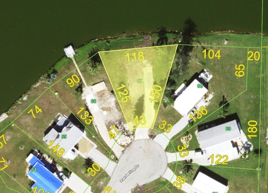 I am thrilled to present to you a truly remarkable opportunity - a CLEARED WATERFRONT vacant lot including water and electricity onsite and a large concrete pad.  Located right in the heart of Englewood, Florida and ready for your new mobile home. This WATERFRONT GEM is in a X 500 flood zone, boasting public water, sewer, and electricity available. But that's not all - this lot is situated in an active and growing 55 plus waterfront community, offering an unparalleled lifestyle for those seeking a vibrant and engaging community. Imagine being just a five-minute drive away from the stunning Manasota Key, where you can indulge in the beauty of four public beaches, partake in fishing and boating adventures, and relish in waterfront dining and shopping experiences. For those with a passion for history and culture, you'll be delighted to explore the charming Dearborn Street shops, weekly farmers market, indulge in delectable dining options, and immerse yourself in the local art scene. This vacant lot is not just an investment in property, but an investment in a lifestyle filled with endless possibilities. Whether you dream of building your retirement home, creating a serene retreat, or simply securing a piece of paradise, this lot offers it all. Don't miss out on this incredible opportunity to be part of Englewood's thriving community. Act now and make your dreams a reality.